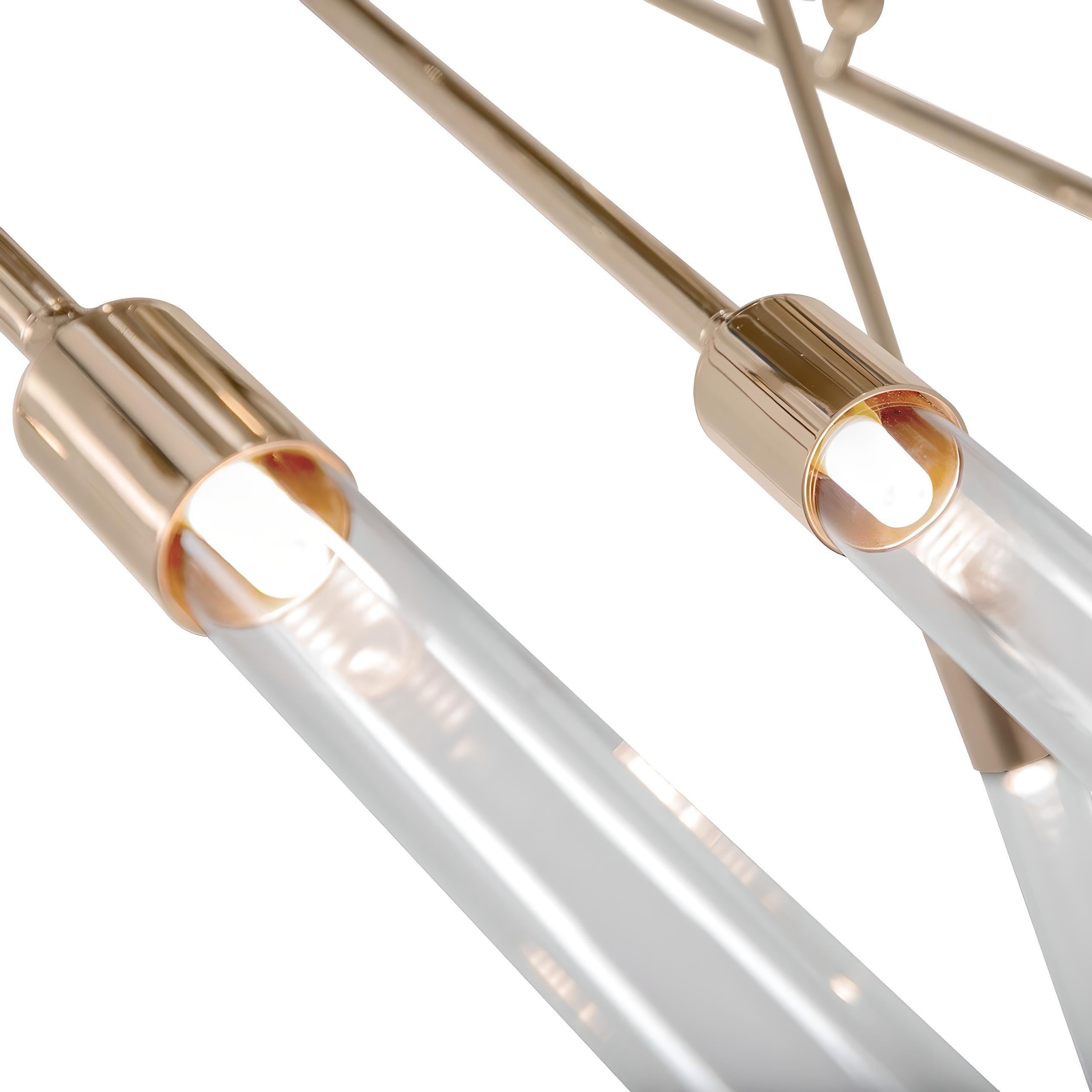 The dynamic lines of this suspension light create an organic flow of sleek brass tubes, as straight as arrows, forming a handmade suspension with glass. The daring angularity of the brass structure is softened by its masculine matte finish and the