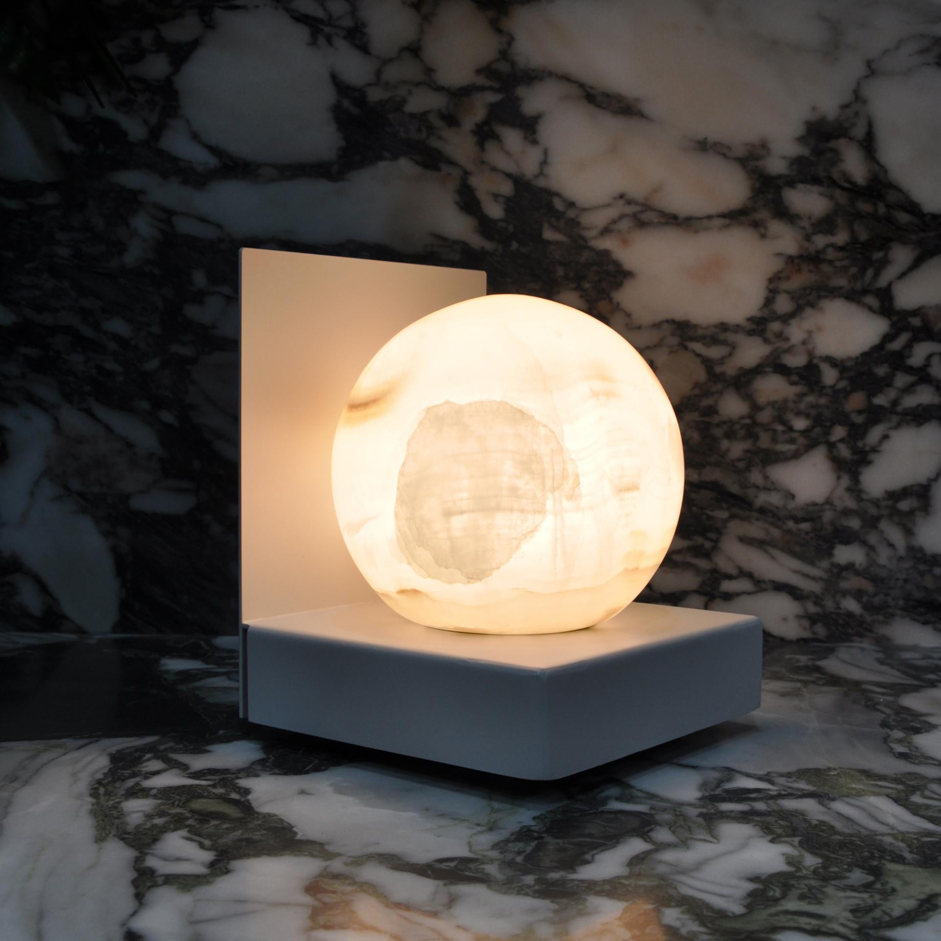 Metal table lamp with sphere in white Carrara marble in collaboration with Anime Design. 

This object gives a distinct touch to your house, kitchen and table, to your office and can be a sophisticated and original gift; you can surprise the