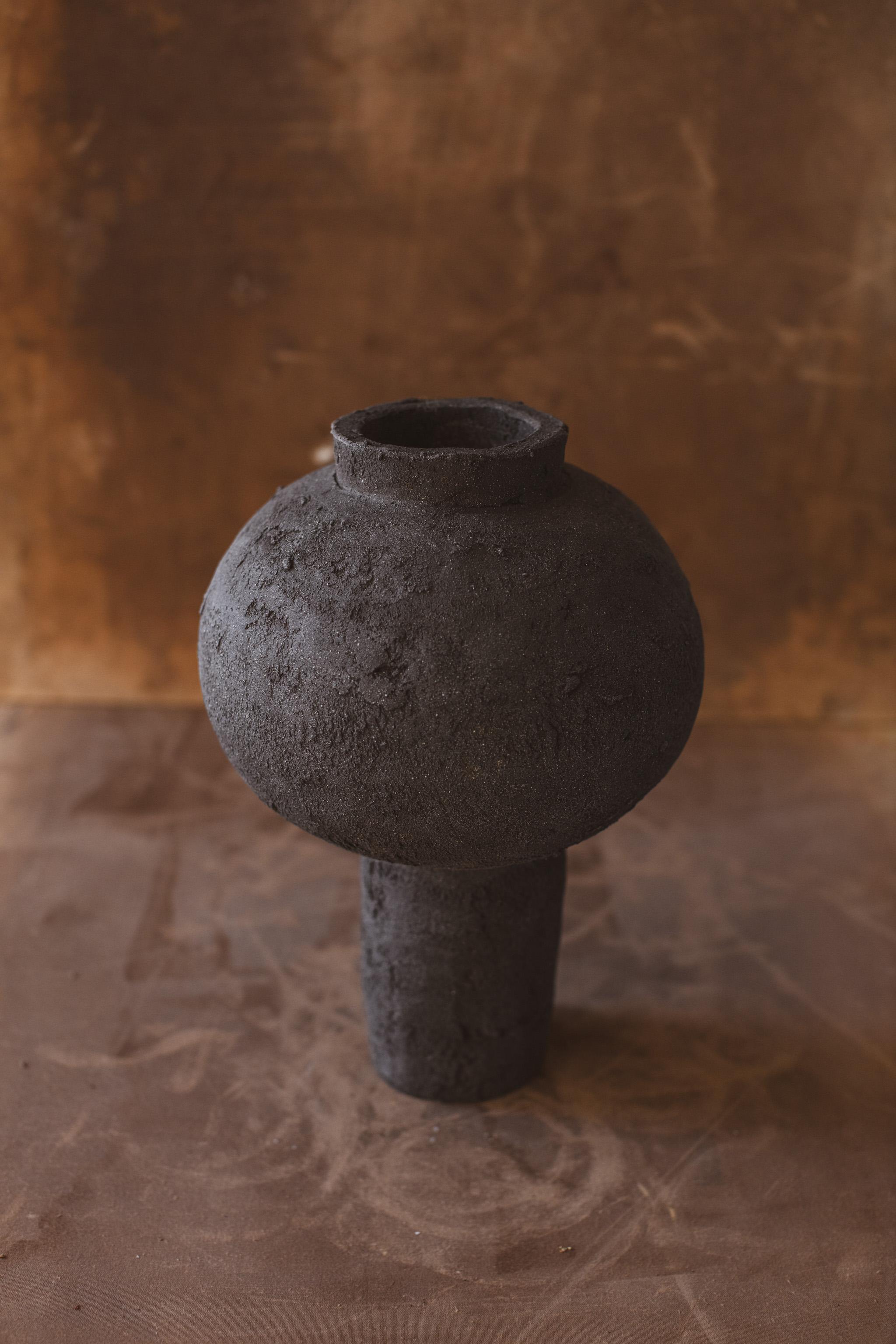 Mugly NYC is a Brooklyn based ceramic studio specializing in richly textured sculptural clay and porcelain that evoke the poetics of the handmade.

This Moon Jar was handmade in 2022 with highly textured black sculpture clay to create a raw look,