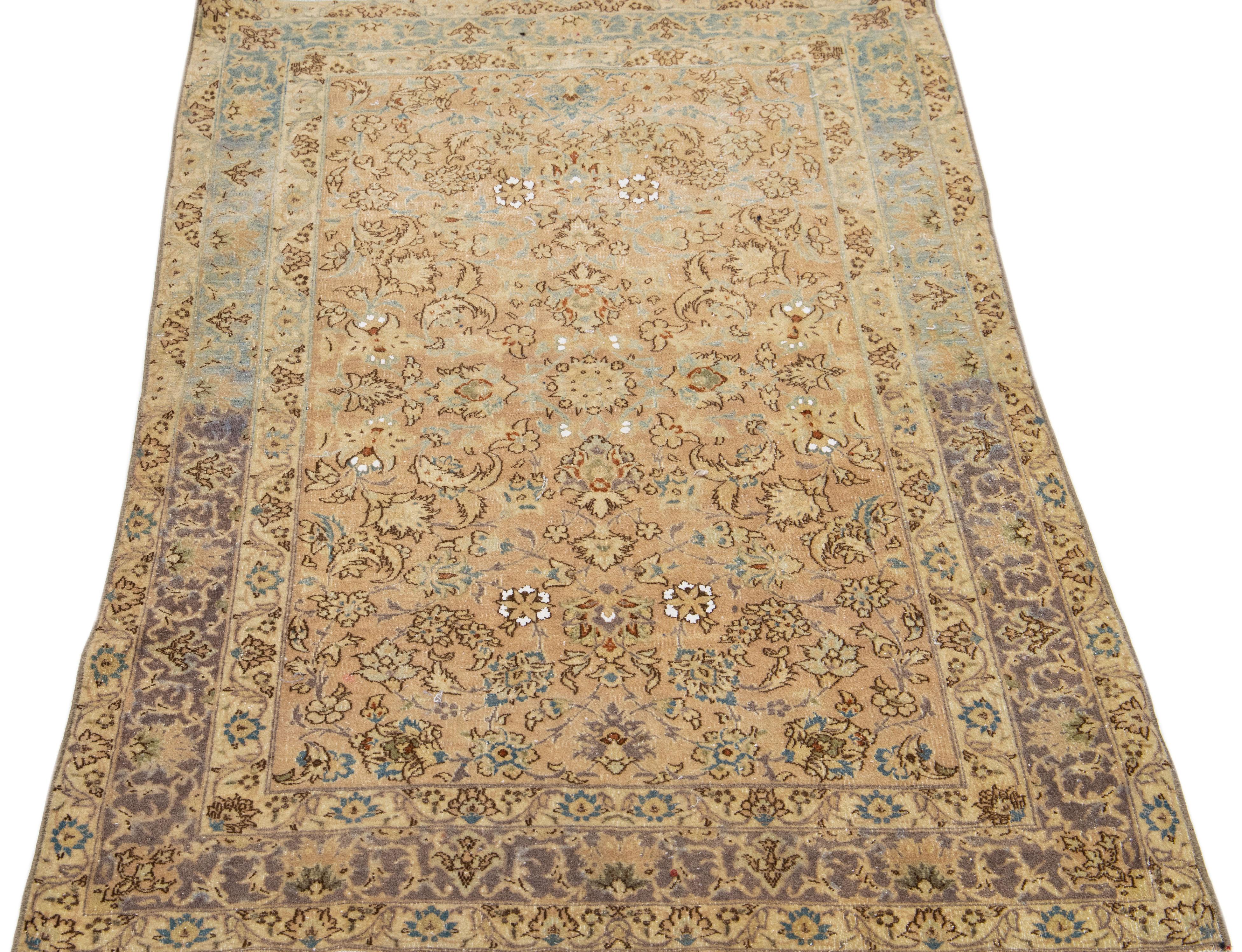 Beautiful antique Kirman hand-knotted wool runner with a beige color field. This Persian rug has a blue frame and accents in a gorgeous all-over floral motif.

This rug measures: 3' x 4'9