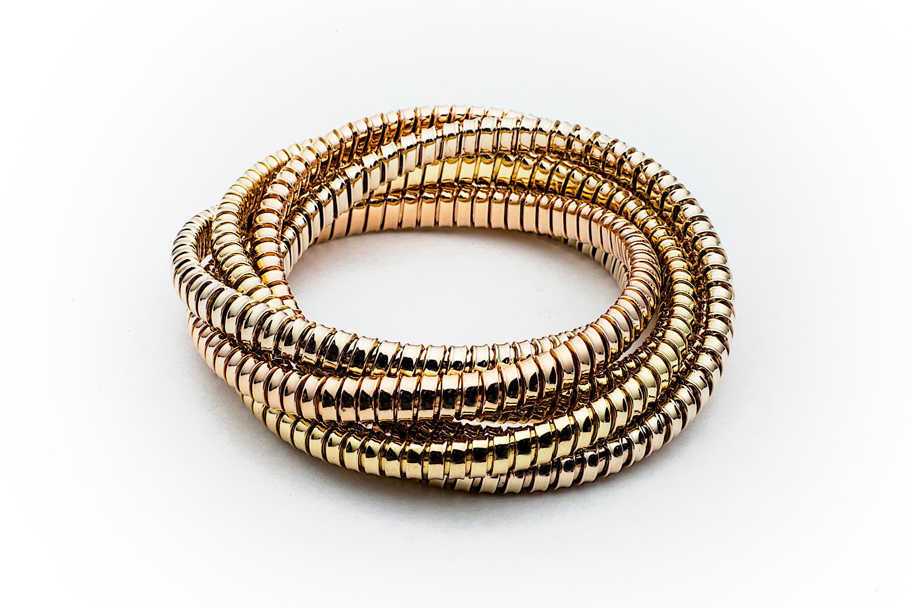 With a timeless but modern style, this chic intertwined six strand 6.5 mm tubogas rolling bangle bracelet was originally inspired by the flexible automotive gas tubing of the 1920’s. Translated into luxurious 18 karat white, rose and yellow gold and