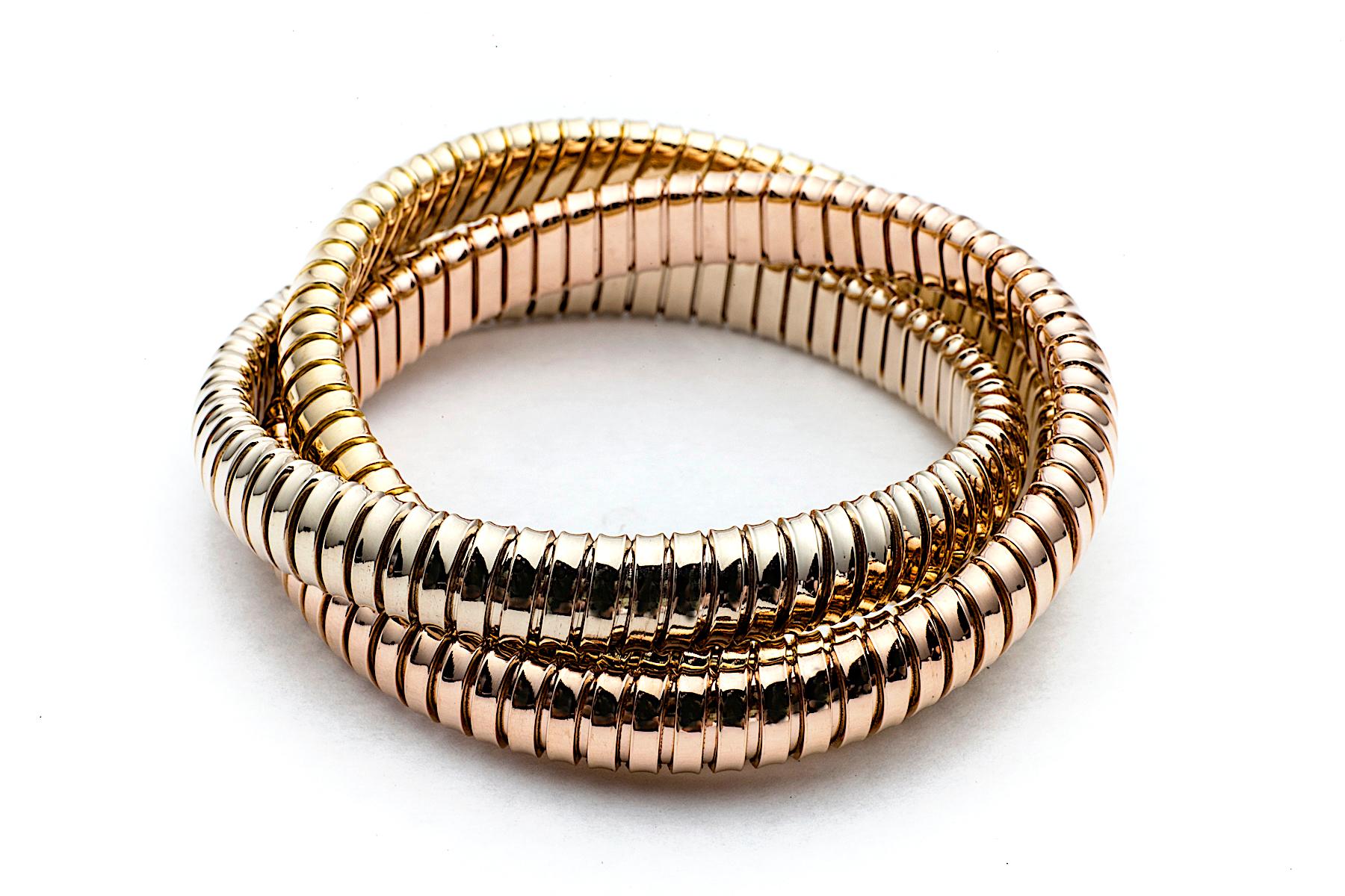  With a timeless but modern style, this chic intertwined three strand 9mm tubogas rolling bangle bracelet was originally inspired by the flexible automotive gas tubing of the 1920’s.  Translated into luxurious 18 karat white, rose and yellow gold