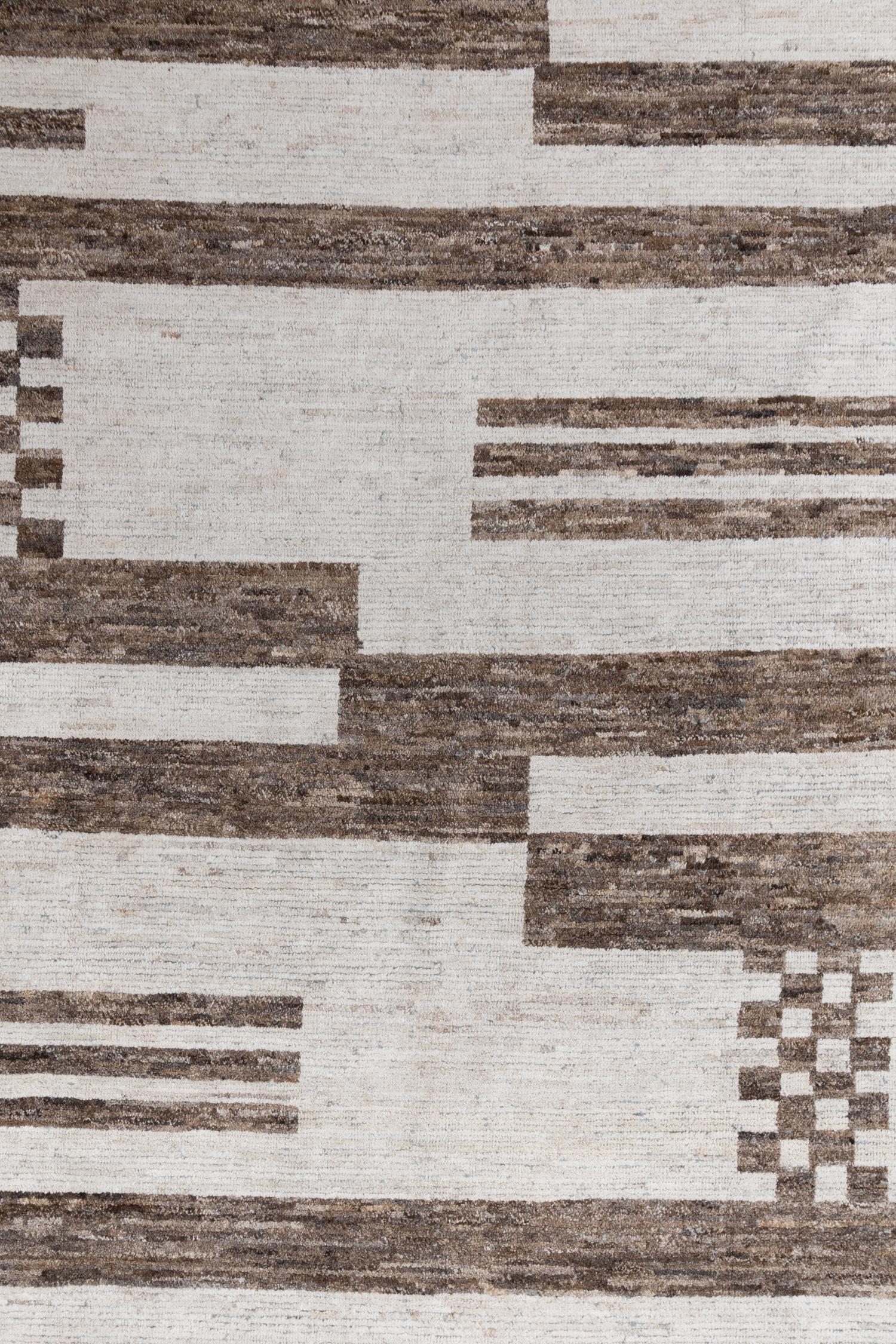 Crafted by hand using 100% wool, this Tulu pile rug features a neutral palette of off-white and brown with a stylish geometric pattern and checkered accents, providing a modern look that is also soft and inviting.

Wear Guide: New

Wear