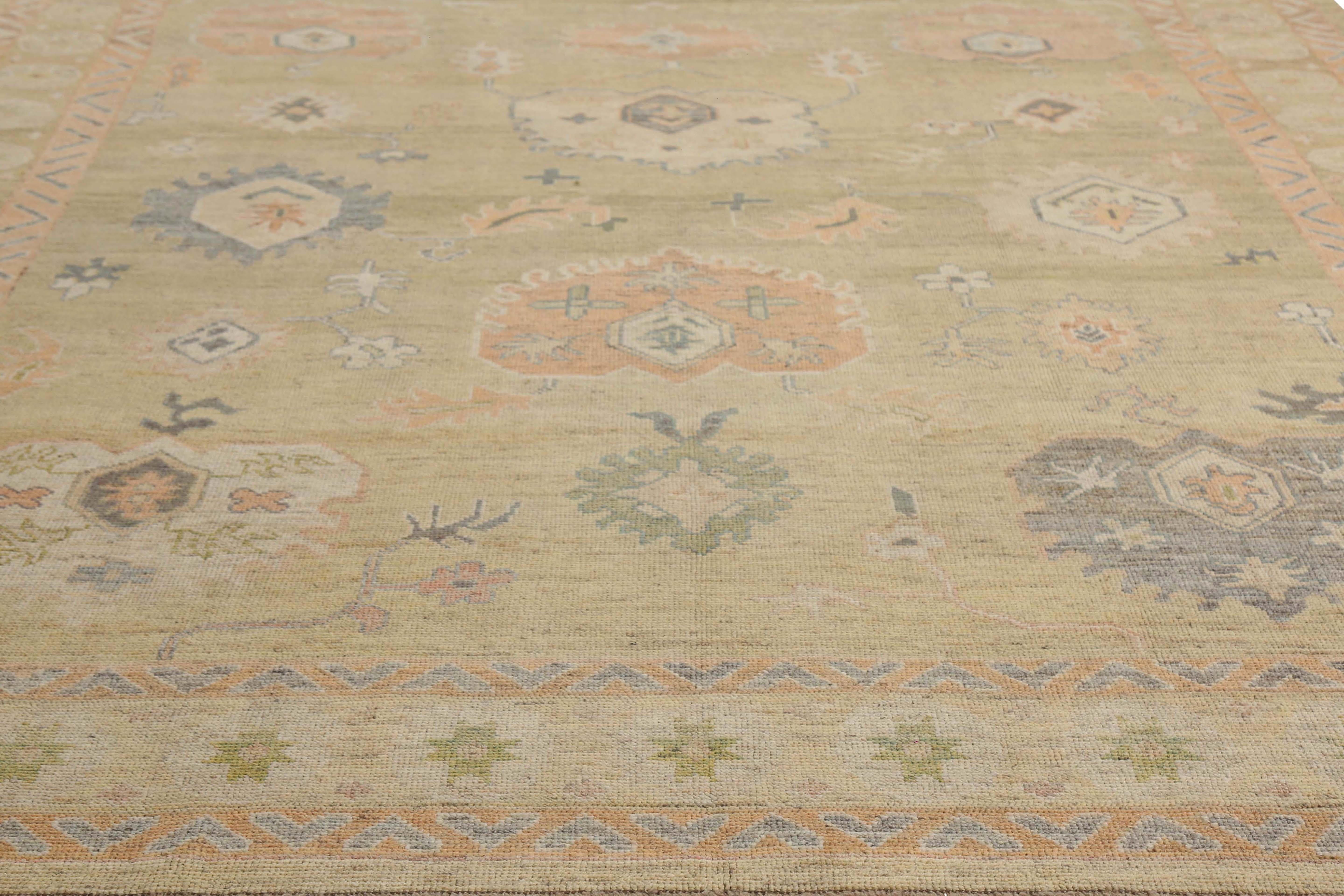 This exquisite 9'8'' x 12'10'' Oushak rug is a true masterpiece of Turkish craftsmanship. The rug features a stunning beige background with natural coloring that will complement any decor style. The design is composed of intricate motifs in blue,