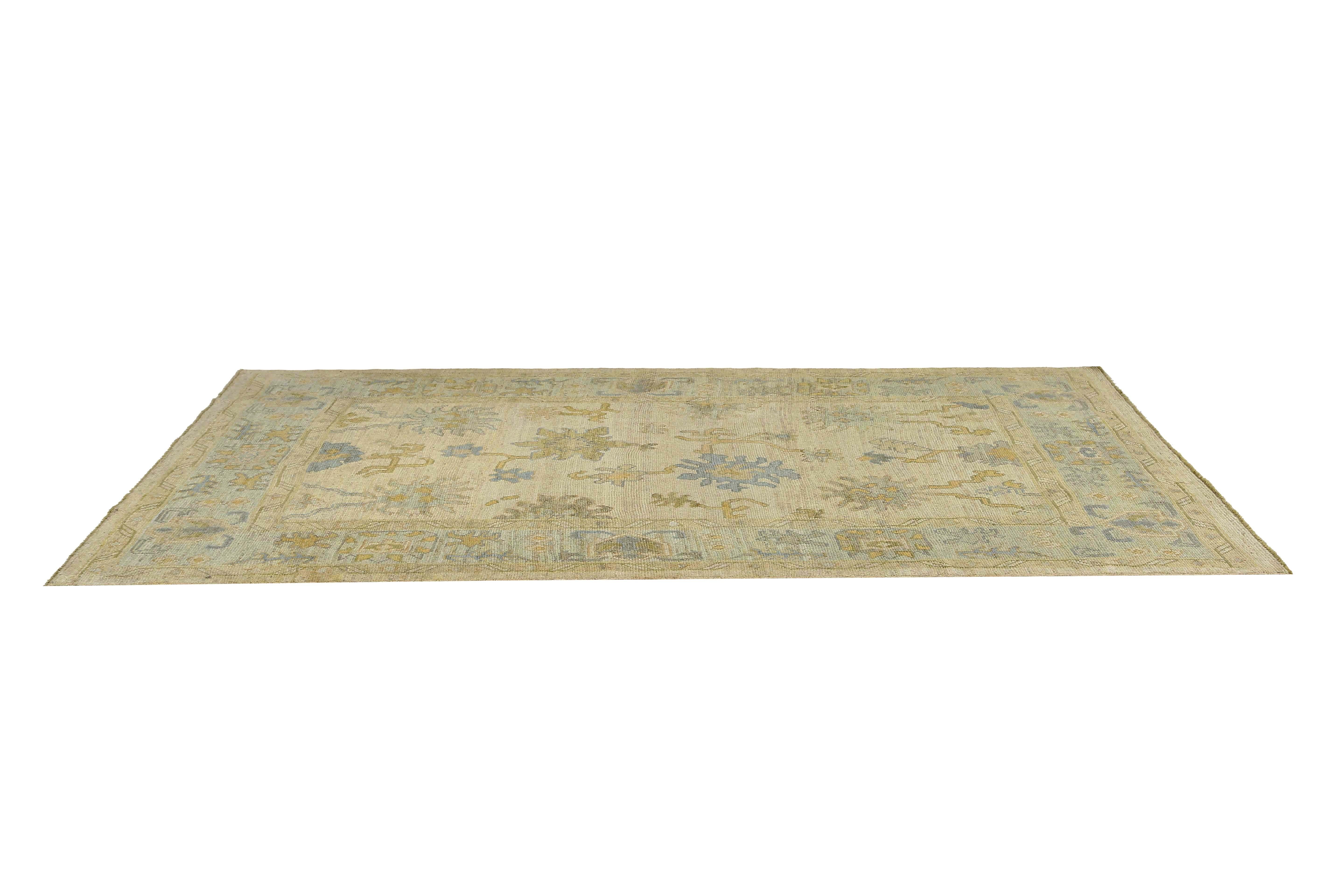 Bring a touch of elegance to your home with this exquisite Turkish Oushak rug. Handmade with care, this rug boasts a beautiful floral design that is sure to impress your guests. The colors of brown, green, and blue blend seamlessly together,