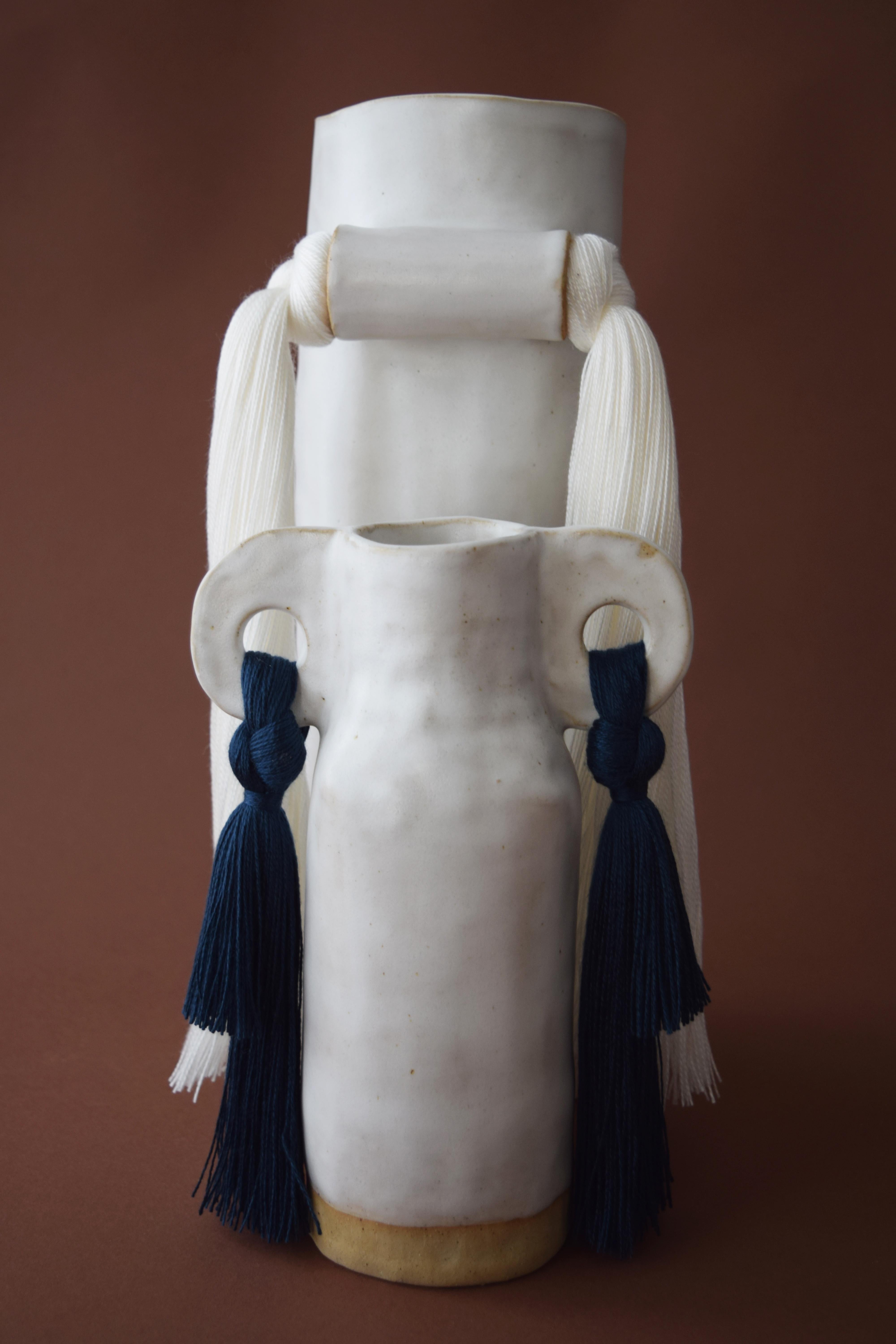 Vase #531 by Karen Gayle Tinney

Quiet symmetry and front-facing fringe details make this vase perfect for display on a shelf or table.

Hand formed beige stoneware with satin white glaze with white tencel fringe detail. Inside is glazed white,