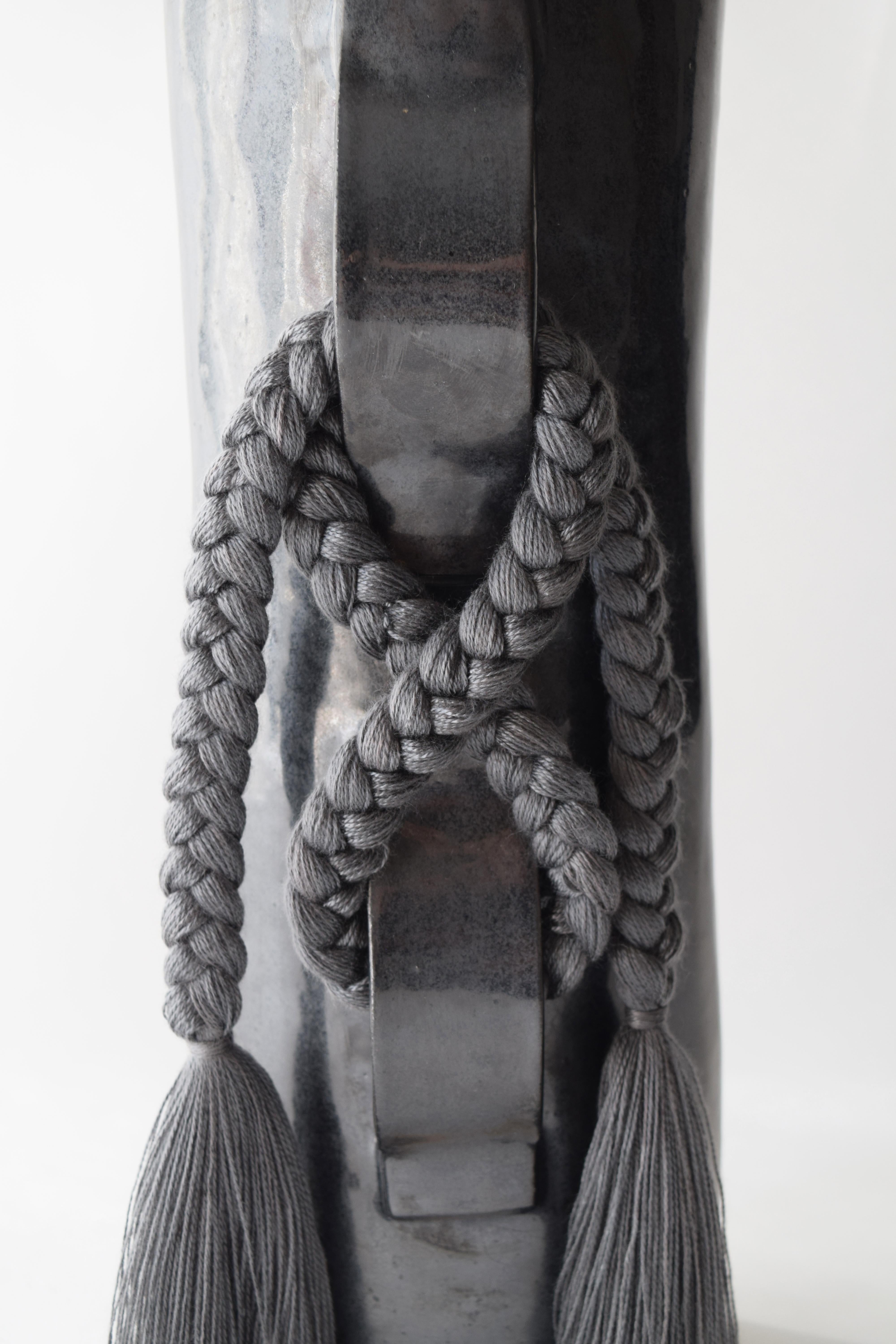 Vase #696 by Karen Gayle Tinney

Featuring a large gestural knot, this vase takes inspiration from the braided details of Karen’s one of a kind wall sculptures.

Hand formed stoneware with black glaze. Charcoal tencel braided details (braid is sewn