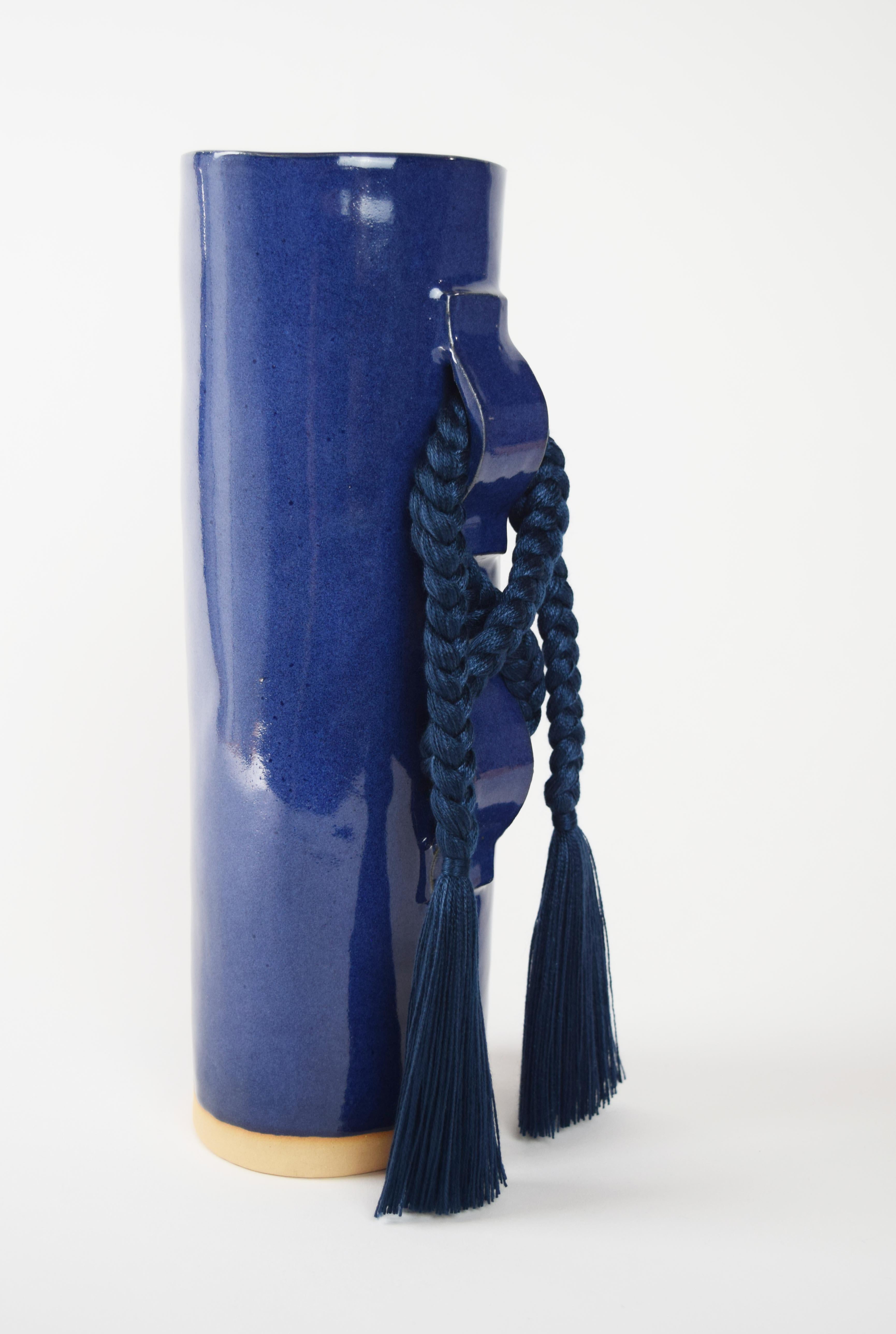 Vase #696 by Karen Gayle Tinney

Featuring a large gestural knot, this vase takes inspiration from the braided details of Karen’s one of a kind wall sculptures.

Hand formed stoneware with deep blue glaze. Navy tencel braided details (braid is sewn