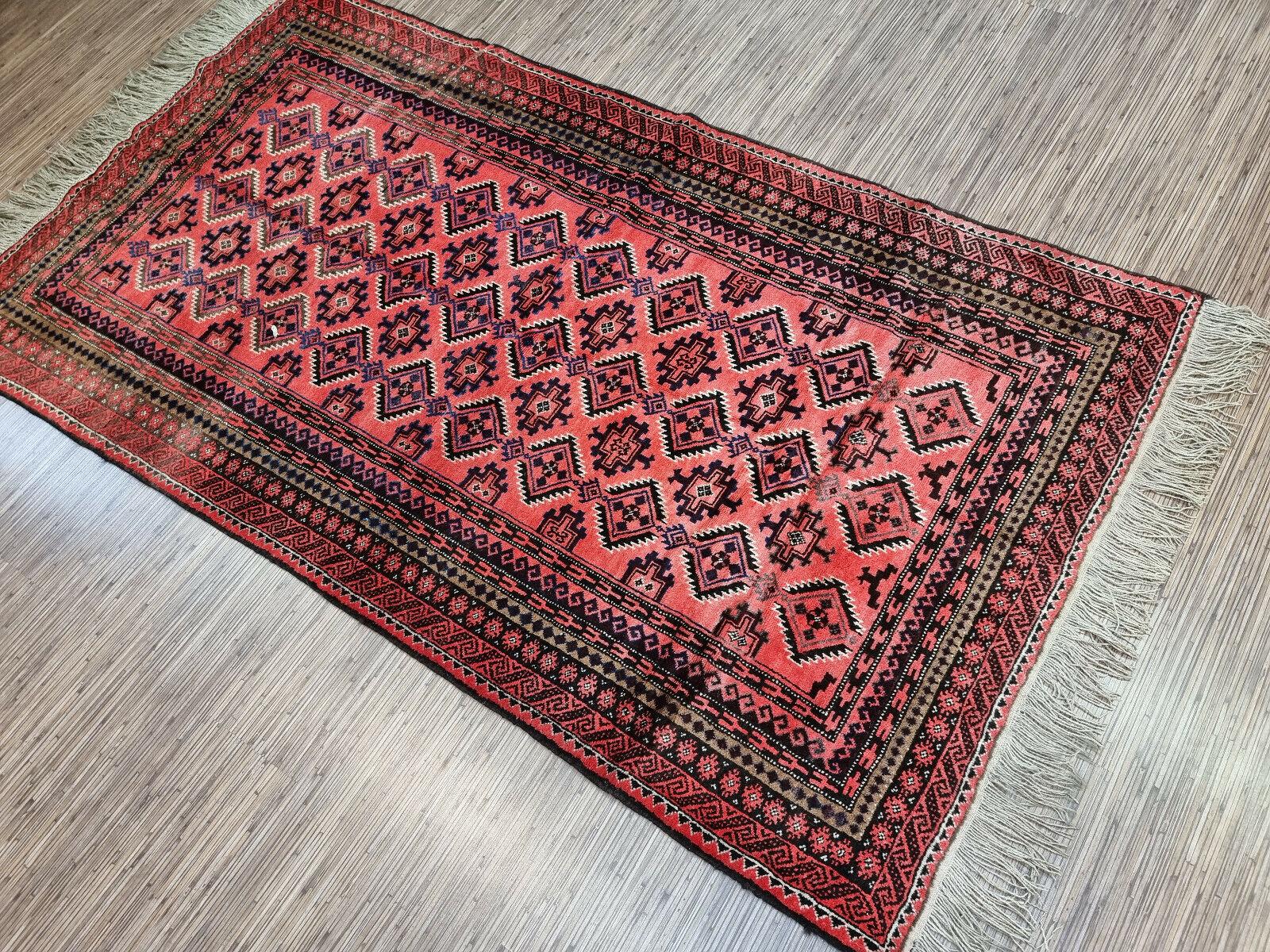 Bring home a piece of history and culture with our Handmade Vintage Afghan Baluch Prayer Rug. This stunning rug is a testament to the skill and craftsmanship of the Afghan Baluch people, who have been weaving rugs for centuries. This rug dates back