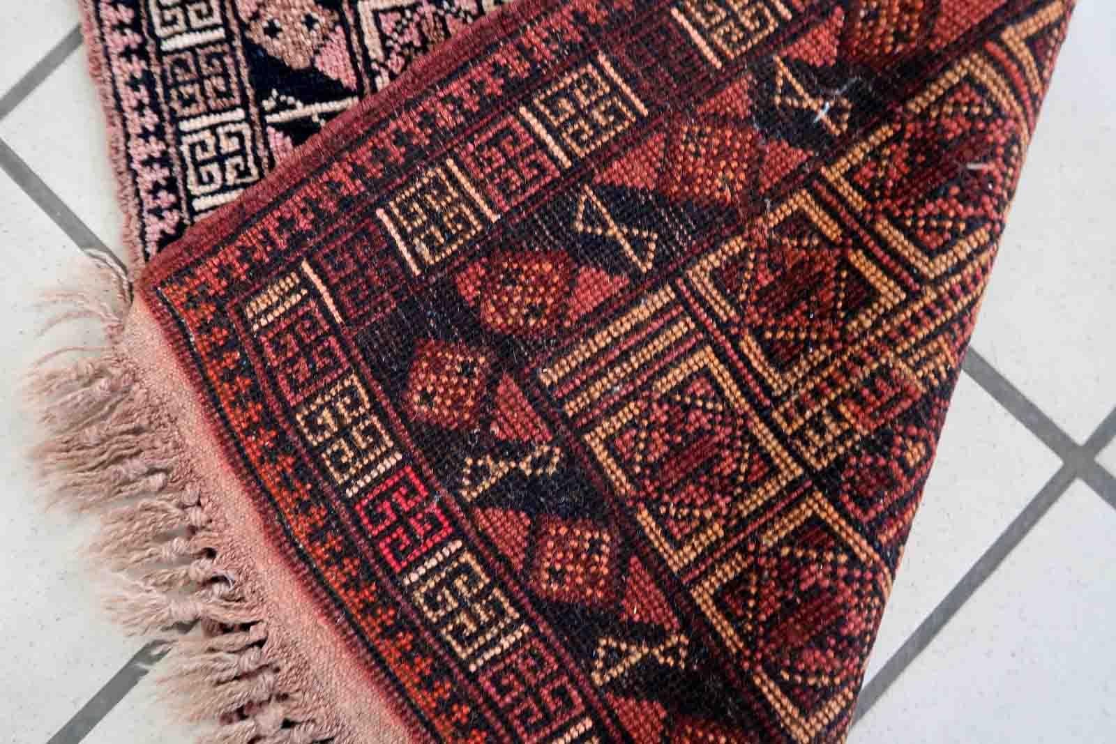 Handmade vintage Afghan Baluch rug in unusual tribal design and beautiful combination of colors. The rug is from the middle of 20th century in original good condition.

-condition: original good,

-circa: 1950s,

-size: 1.6' x 2.7' (50cm x