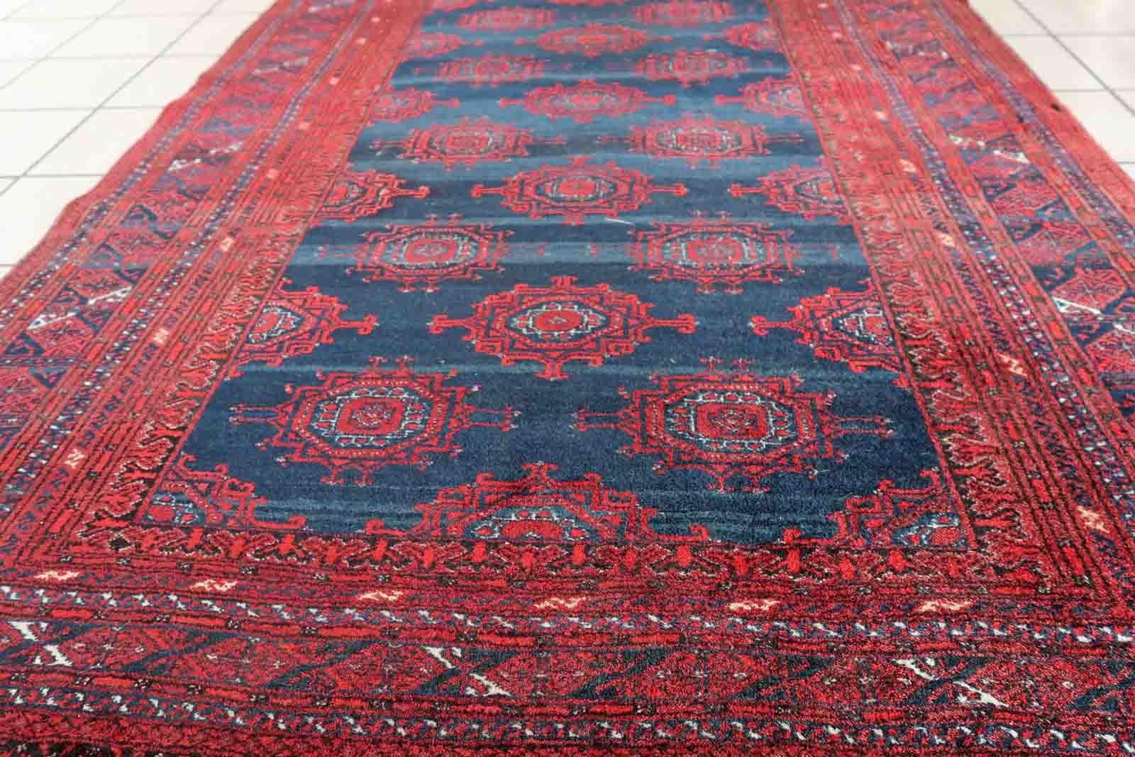 Handmade vintage Afghan Baluch rug in bright red and dark blue shades. The rug is from the middle of 20th century in original good condition.

-condition: original good,

-circa: 1950s,

-Size: 3.9' x 5.8' (120cm x 179cm),

-Material: