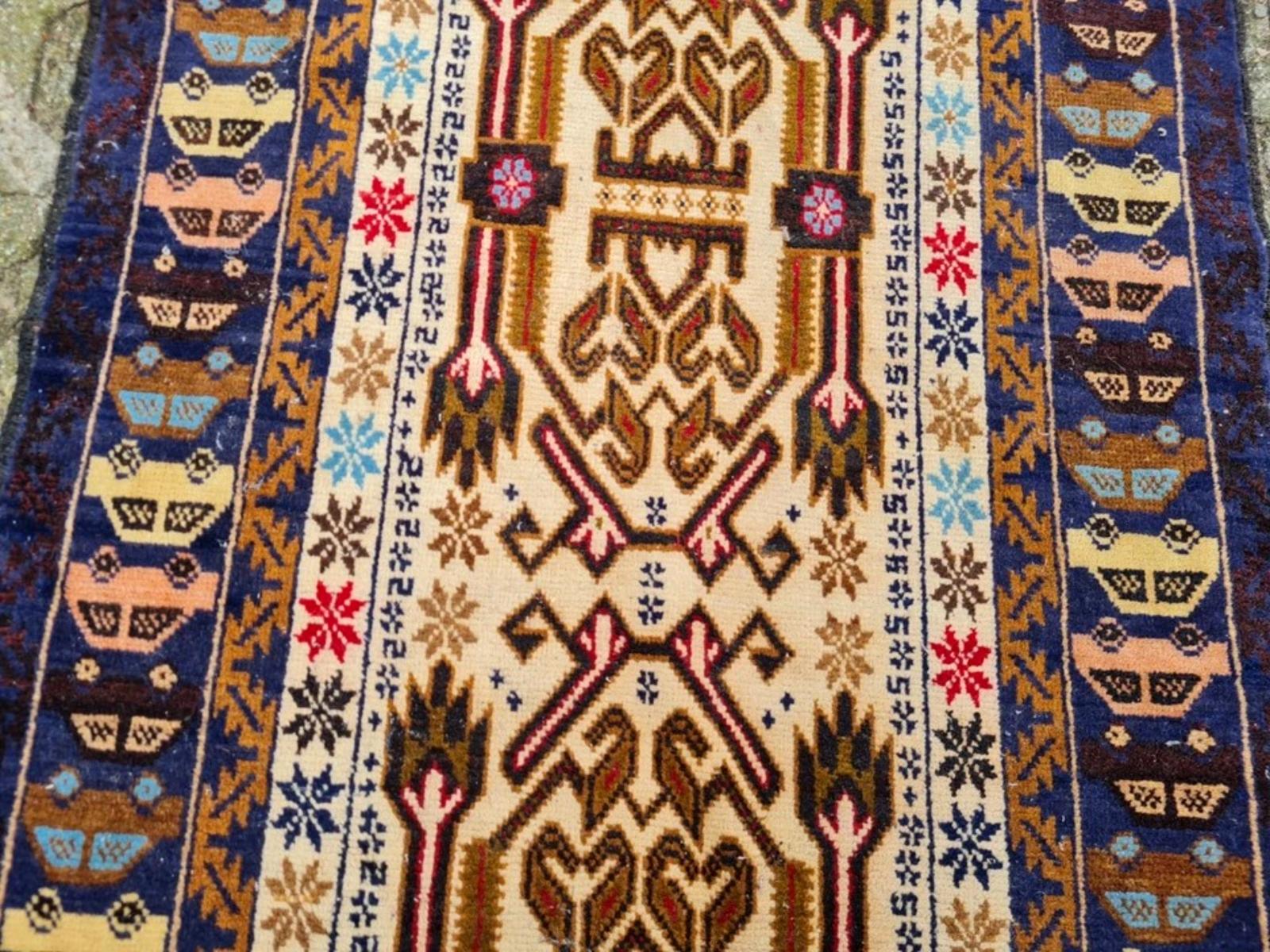 A Unique Blend of Tradition and Modernity: Vintage Afghan Baluch
Discover the unparalleled charm and distinctive artistry of this handmade vintage Afghan Baluch rug, originating from the nomadic Baluch tribes of Afghanistan and dating from the