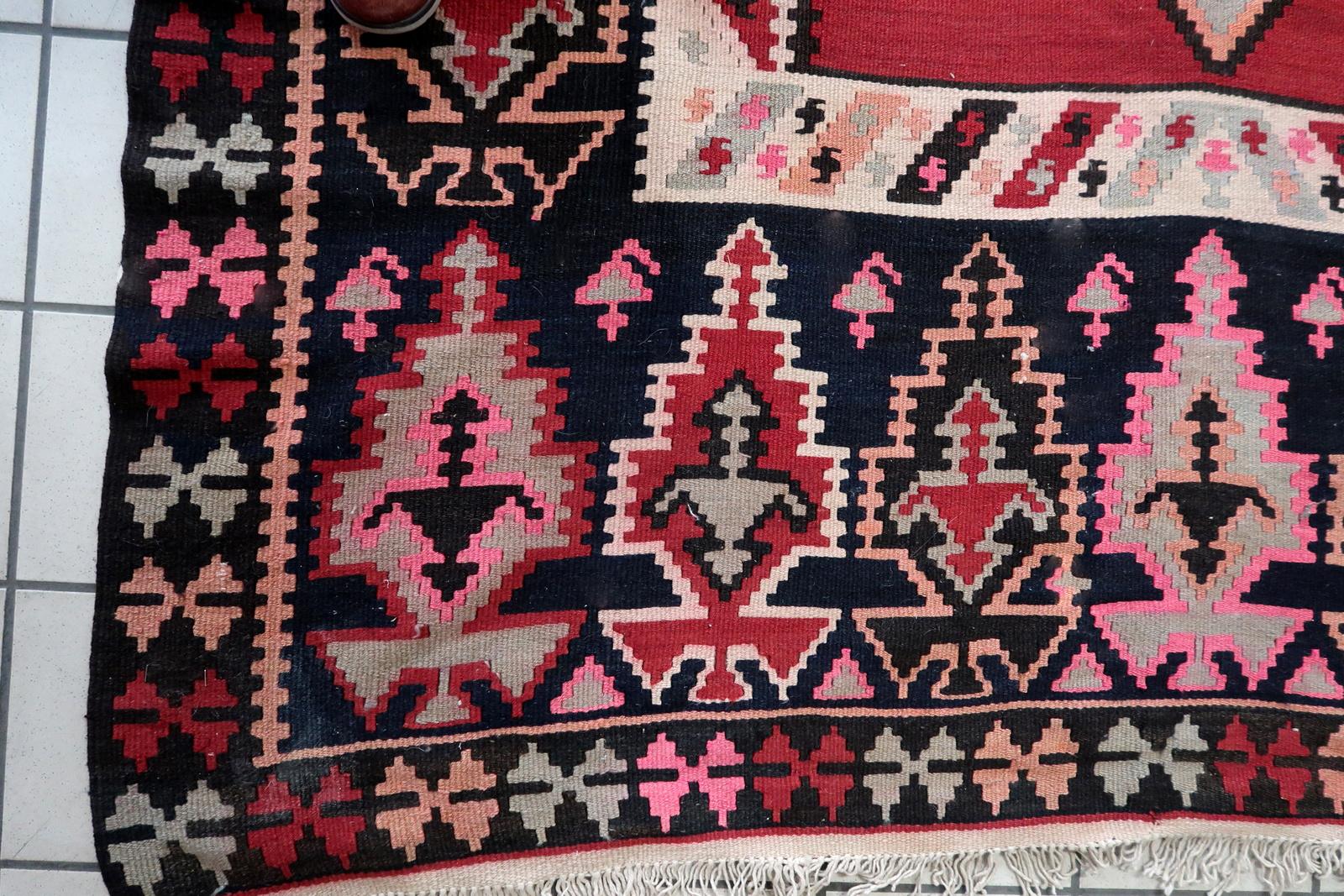 Add a splash of color and culture to your space with this Handmade Vintage Afghan Herati Kilim. Created in the 1960s, this extraordinary kilim measures 5.2' x 12.1' (160cm x 371cm) and is in good condition with some charming signs of age. Crafted