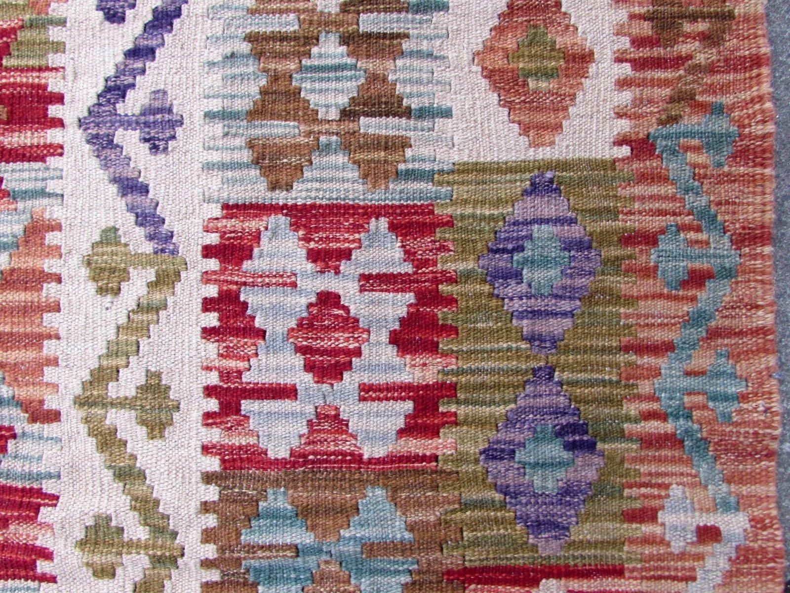 Handmade vintage Afghan flat-weave in geometric design. The rug is from the end of the 20th century in original good condition.

- Condition: original good,

- circa: 1970s,

- Size: 5.9' x 8.1' (181cm x 247cm),

- Material: wool,

-
