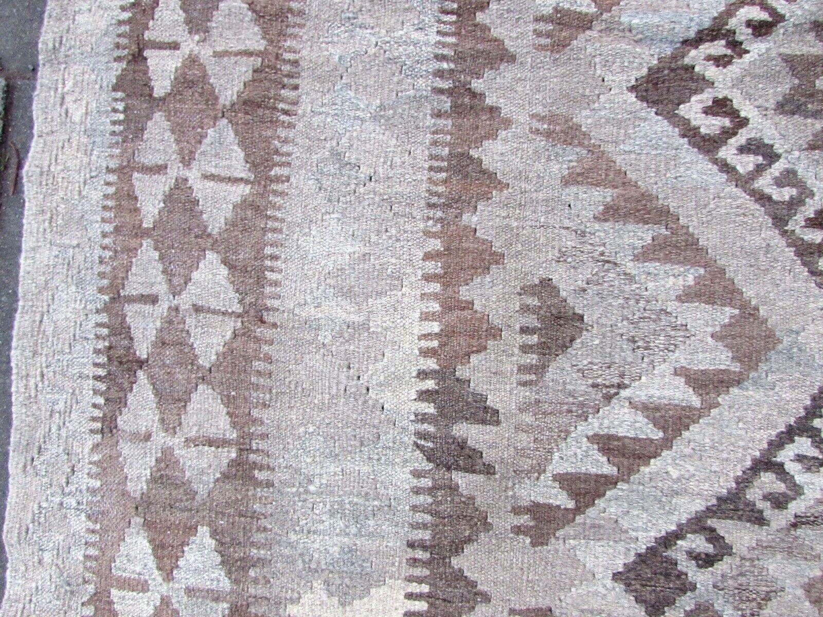 Handmade vintage Aghan flat-weave rug in white, gray and brown wool. It is from the end of 20th century in original good condition.

- Condition: original good,

- circa 1970s,

- Size: 6' x 8.5' (185cm x 260cm),

- Material: wool,

-