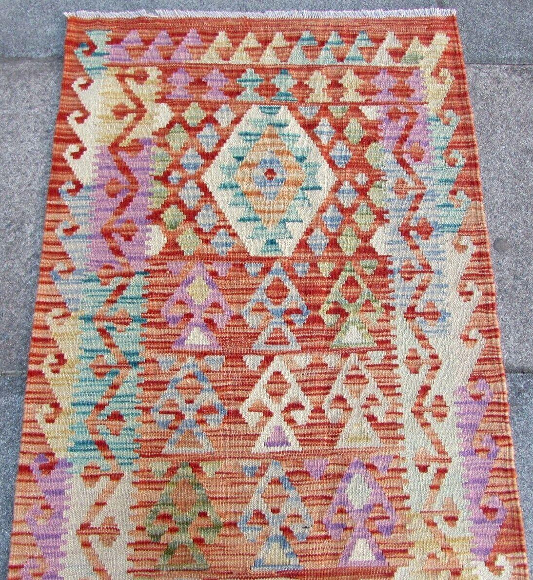 This handmade vintage Afghan kilim runner from the 1980s is a stunning piece of art. The runner measures 2.5 feet wide by 6.5 feet long (77cm x 199cm), making it the perfect size for a hallway, foyer or any narrow space in your home.

Crafted from