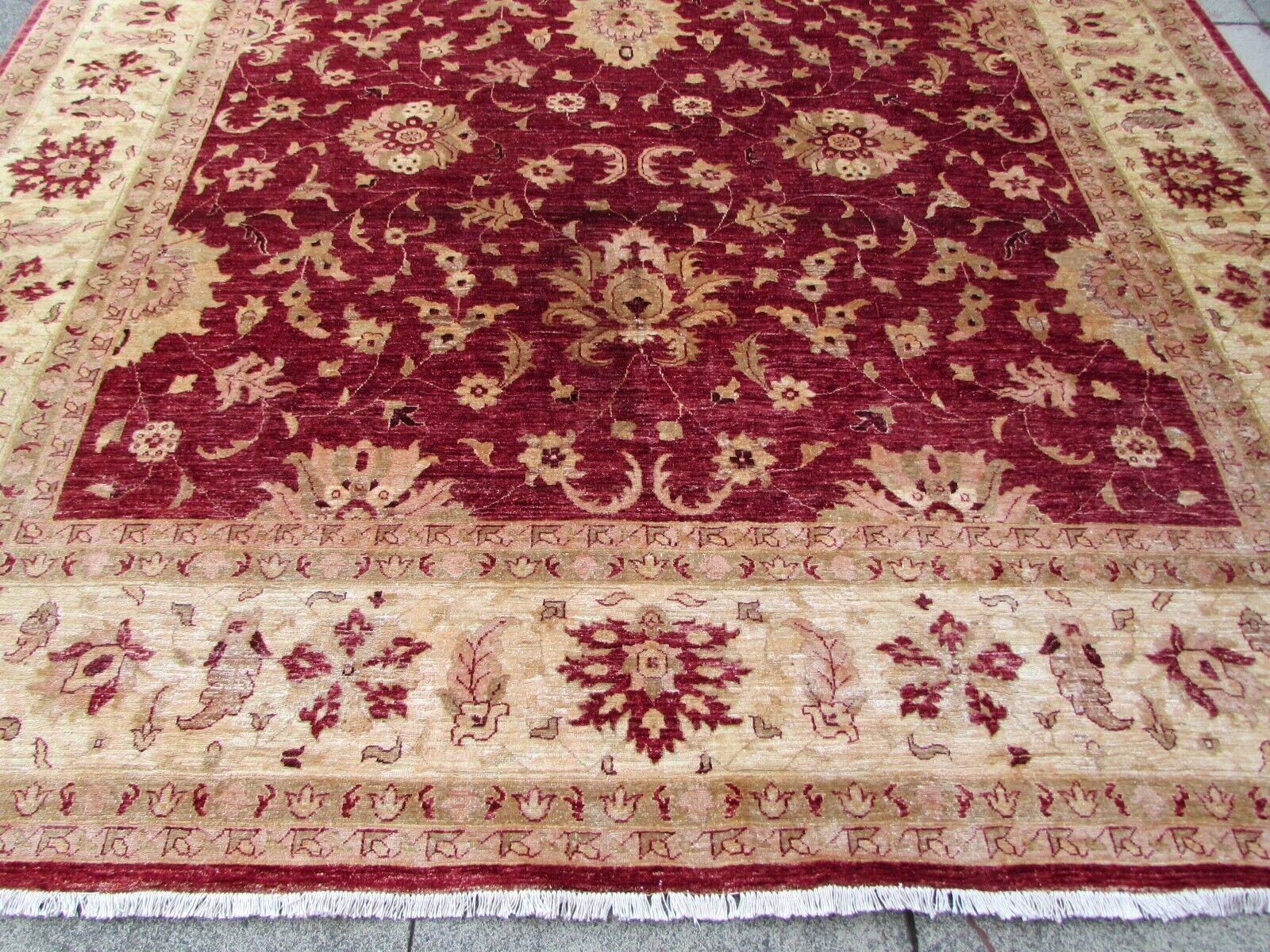 This handmade vintage Afghan Zigler rug from the 1980s is a stunning piece of craftsmanship, made from high-quality wool that is both durable and long-lasting. The wool has been carefully hand-spun and hand-dyed, resulting in a unique texture and