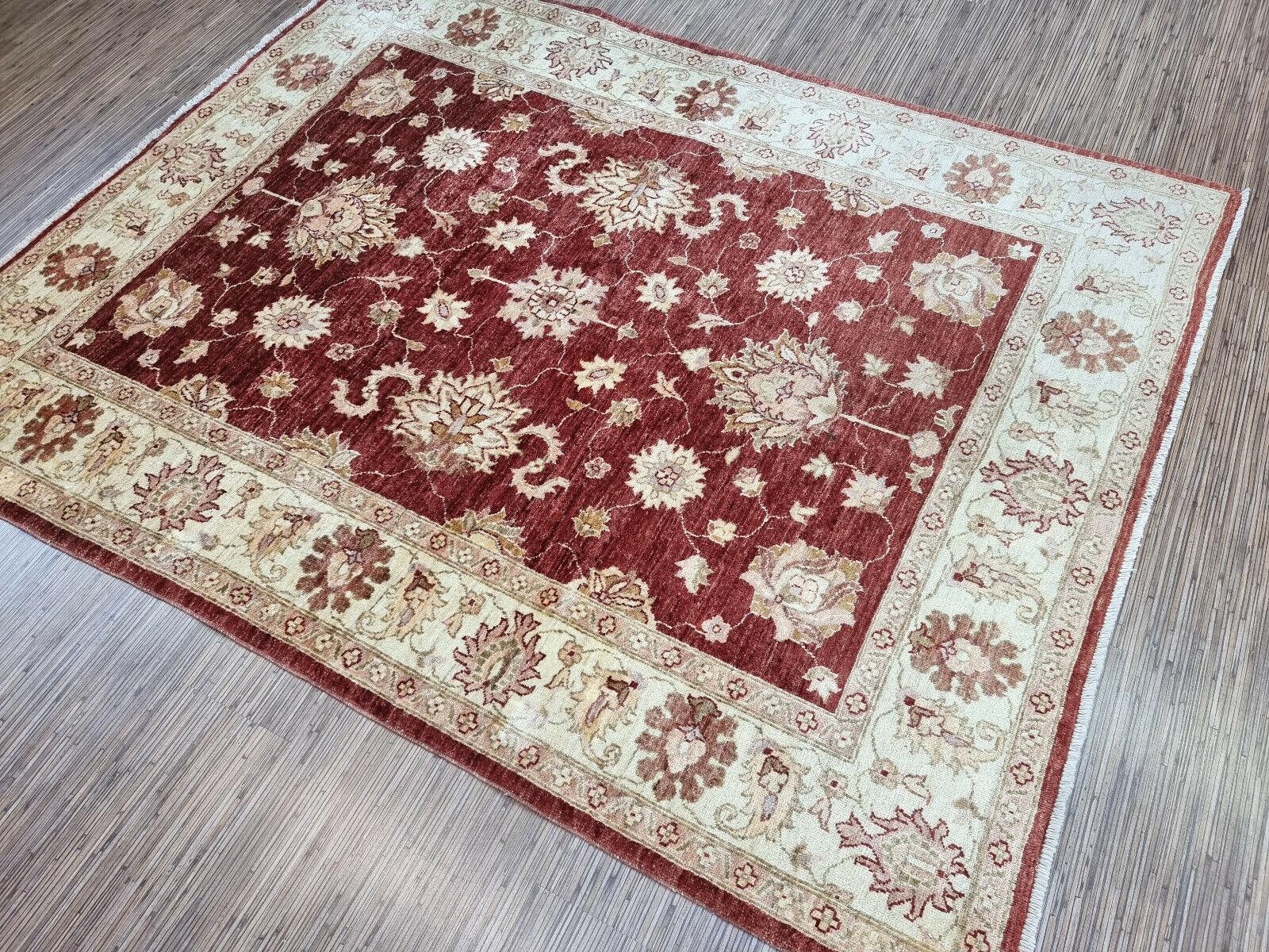 Bring home a piece of history with this Handmade Vintage Afghan Zigler Rug, a beautiful example of the traditional Afghan rug-making style. This wool rug measures 5.1' x 6.4' (156cm x 196cm) and is in good condition, featuring intricate patterns and