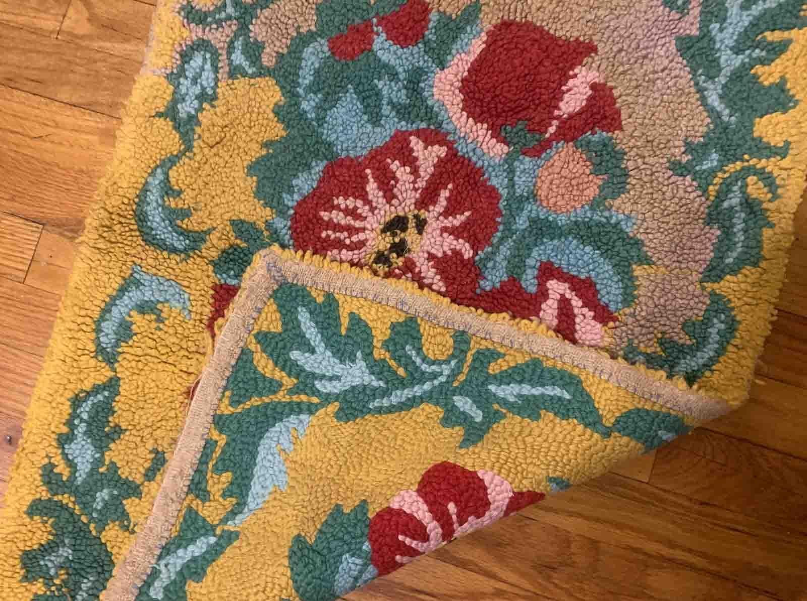 Handmade vintage American Hooked rug in floral design and yellow shade. The rug is from the middle of 20th century in original good condition. 

-condition: original good,

-circa: 1960s,

-size: 1.11' x 2.10' (61cm x 91cm),
?
-material: