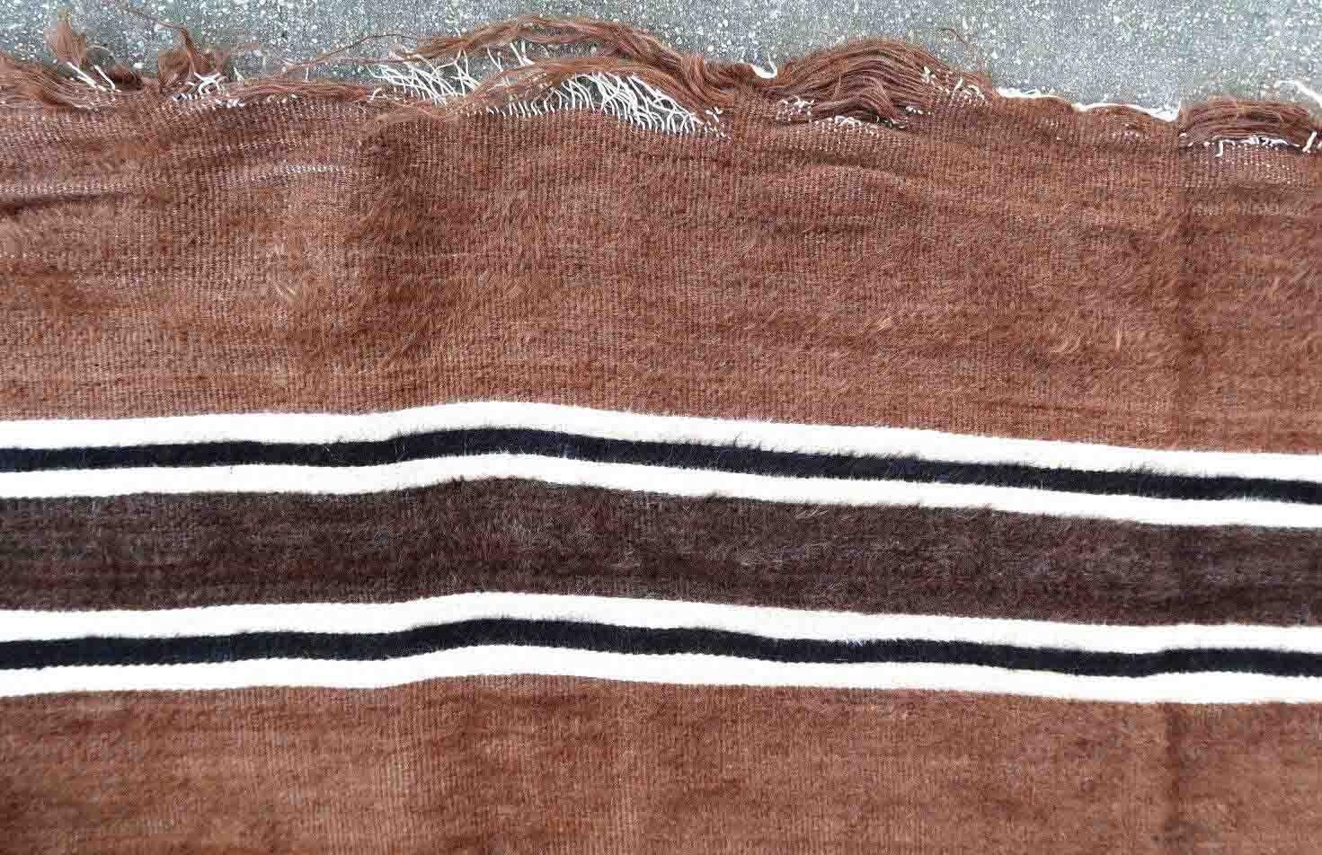 Vintage rug from Syria made in Angora wool in brown color. The rug is from the middle of 20th century in original condition, it has some signs of age.

-condition: original, some signs of age,

-circa: 1950s,

-size: 4.8' x 6.4' (147cm x