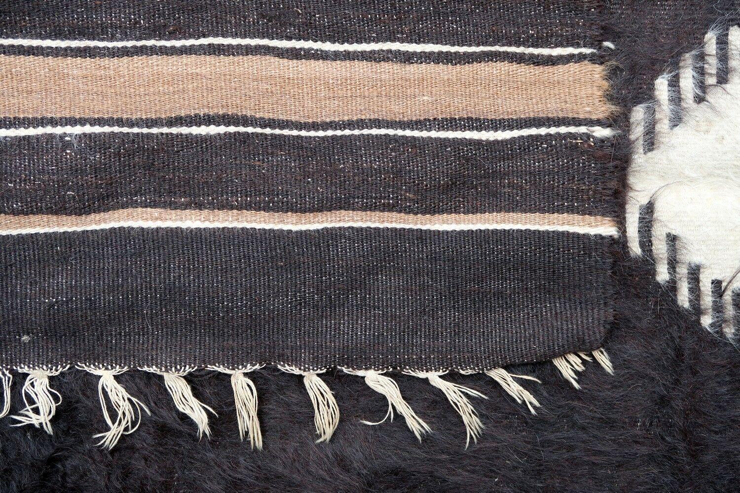 Vintage rug from Syria made in Angora wool in dark brown color. The rug is from the middle of 20th century in original good condition.

-condition: original good,

-circa: 1950s,

-size: 4' x 5.9' (124cm x 180cm),

-material: Angora
