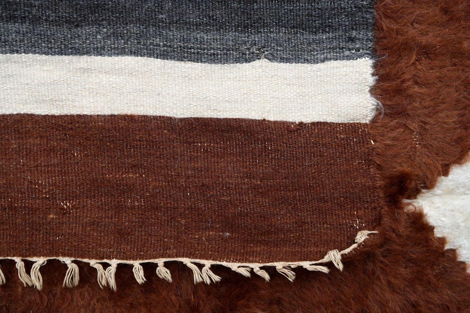 Vintage rug from Syria made in Angora wool in brown color. The rug is from the middle of 20th century in original good condition.

- Condition: original good,

- circa: 1950s,

- Size: 4' x 5.9' (124cm x 180cm),

- Material: Angora