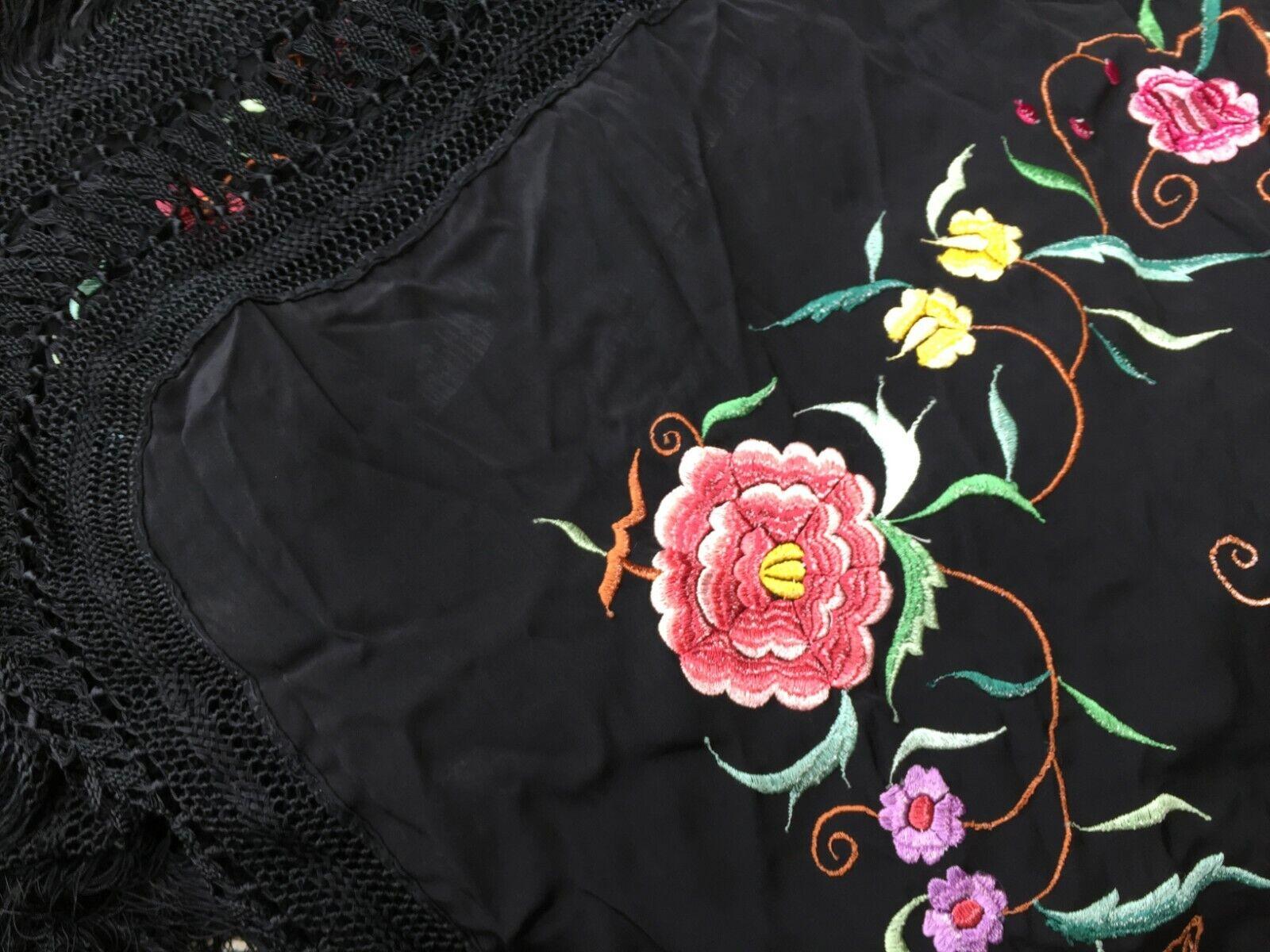 Handmade Vintage Chinese Silk Shawl:

Design and Colors:
This square-shaped shawl is a testament to Chinese craftsmanship.
The dominant color is a rich black, creating a dramatic backdrop for the intricate silk embroideries.
The silk embroideries,