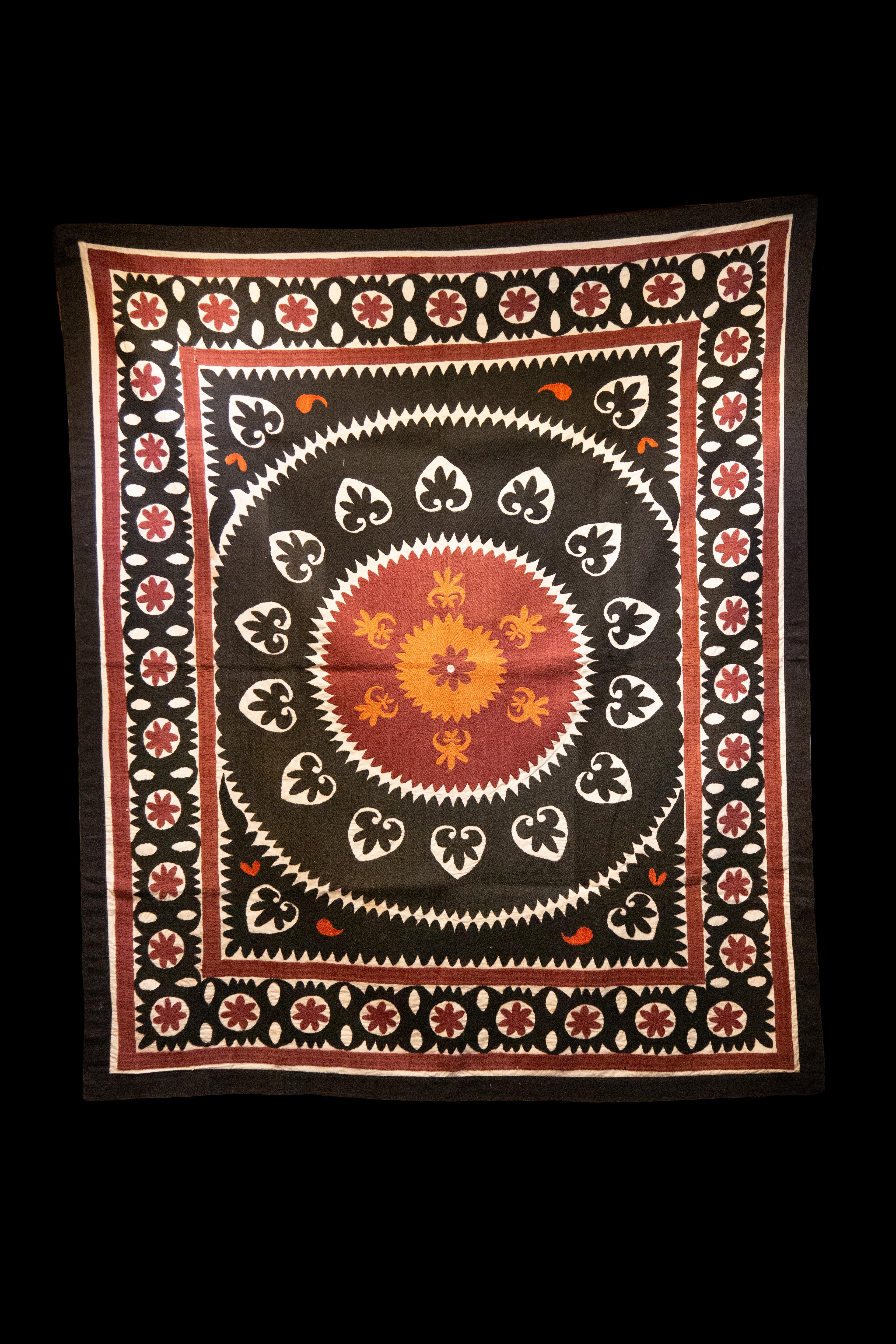 Handmade Vintage cotton suzani, charcoal, orange, and red geometric designs.

Measures: 60.5