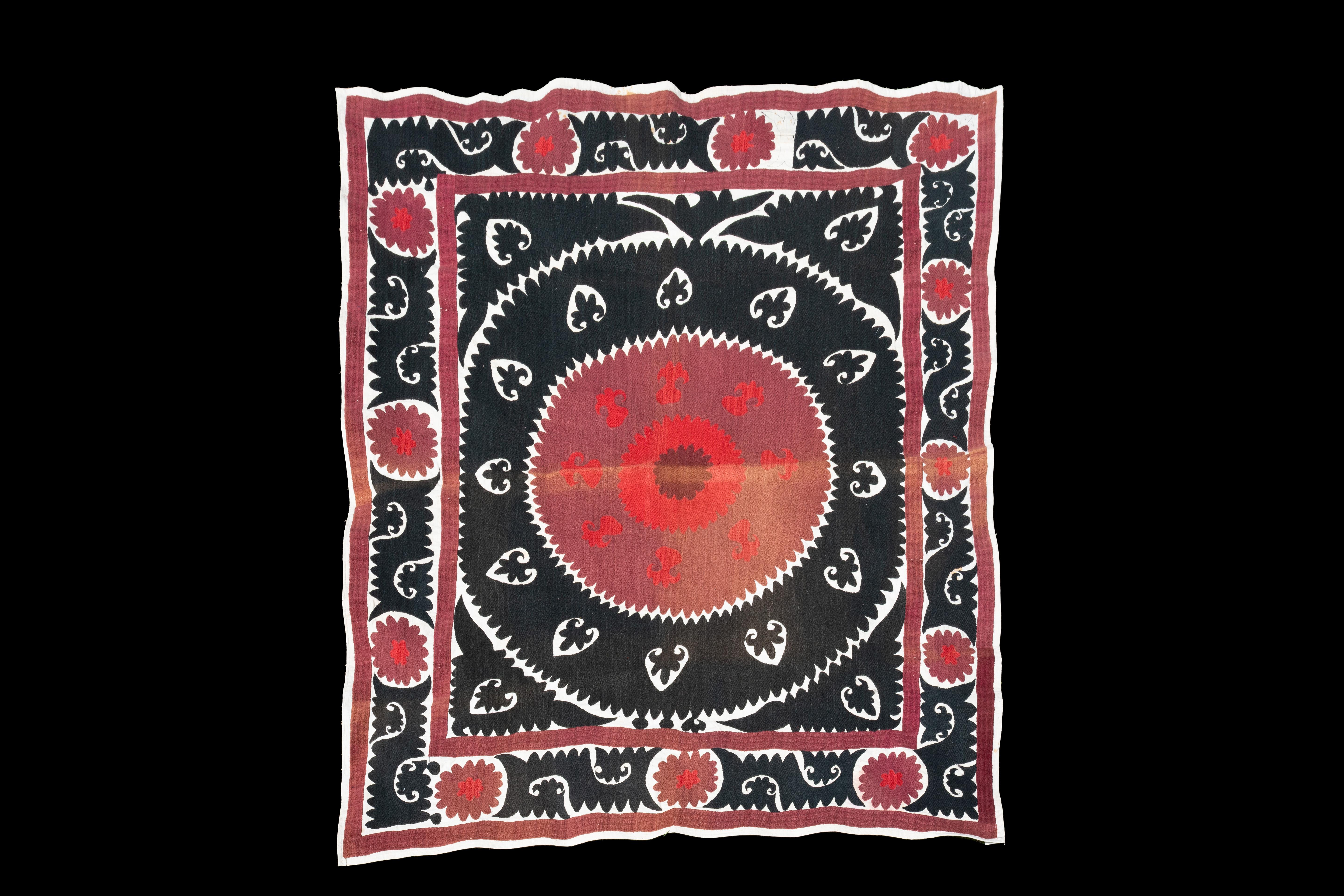 Handmade Vintage Cotton Suzani, Red, Maroon, and Charcoal

Richly hand-embroidered vintage Uzbek suzani in iconic black and copper oranges.
Sun burst flowers are ringed with black scrolls on natural cotton.
Cotton embroidery in tight stitches