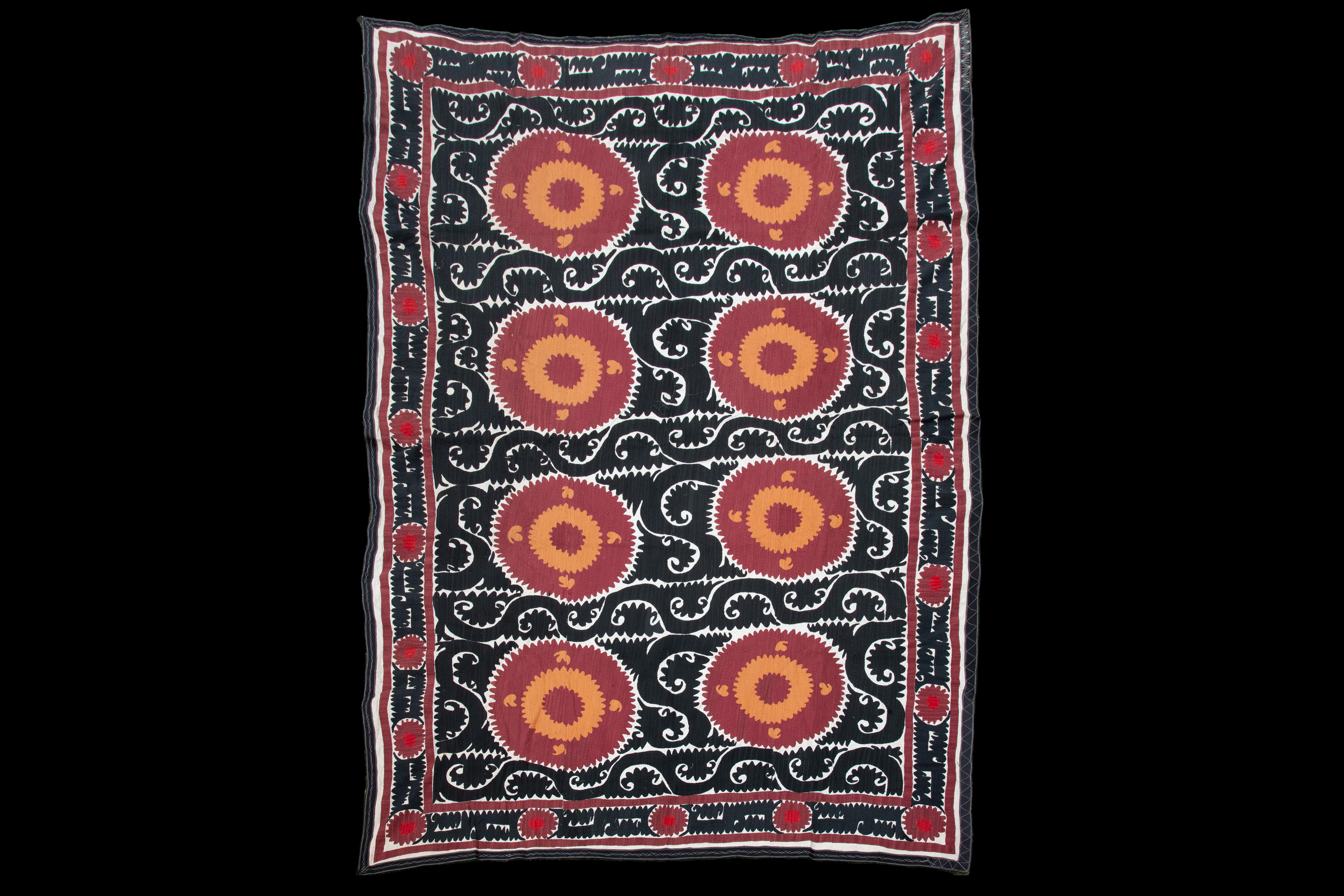 Handmade Vintage Cotton Suzani, Red, Orange, and Black

Richly hand-embroidered vintage Uzbek suzani in iconic black and copper oranges.
Sun burst flowers are ringed with black scrolls on natural cotton.
Cotton embroidery in tight stitches give