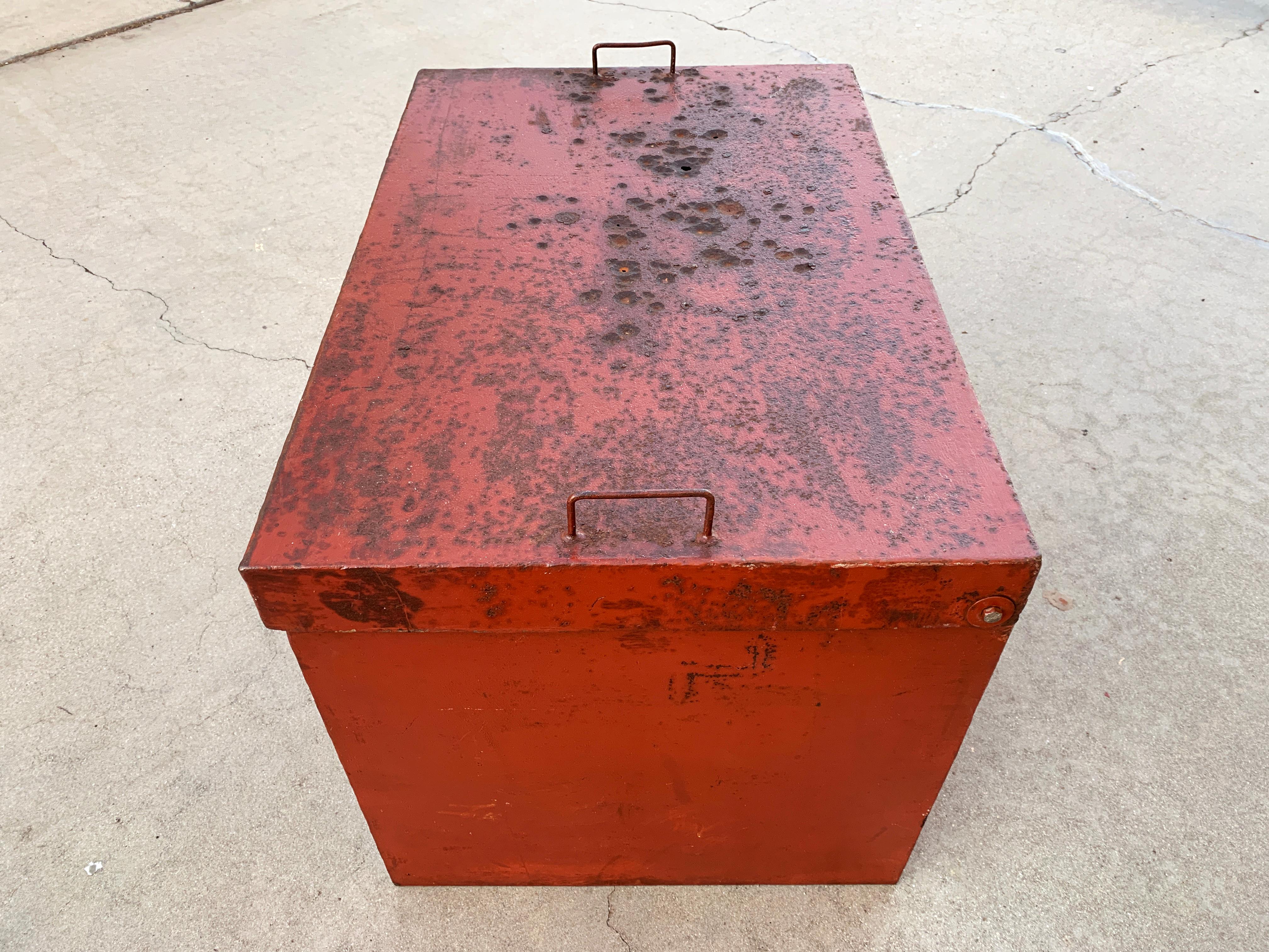 Heavy-duty metal storage box, full of character. It's old, probably dates back to the 1950s. Handmade with distressed red paint and rust patina, this well-made (and very heavy) Industrial piece is truly one-of-a-kind. Complete with an expanded metal