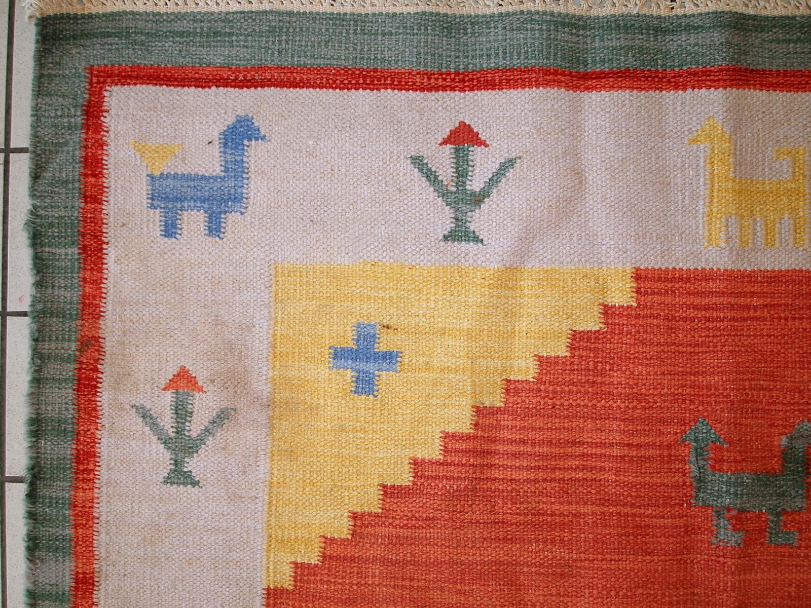 Vintage kilim in bright shades of red, sky blue, beige and yellow. One side of the kilim has some age wear, but generally it is in original good condition.

- Condition: original, one side has some age wear,

- circa 1960s,

- Size: 5.6' x