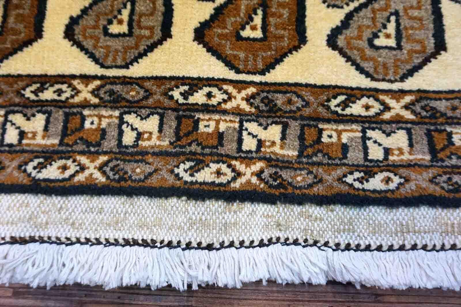 Handmade vintage Gabbeh rug in beige color with repeating paisley design. The rug is from the end of 20th century in original good condition.

-condition: original good,

-circa: 1970s,

-size: 3.2' x 6.1' (99cm x 187cm),

-material: