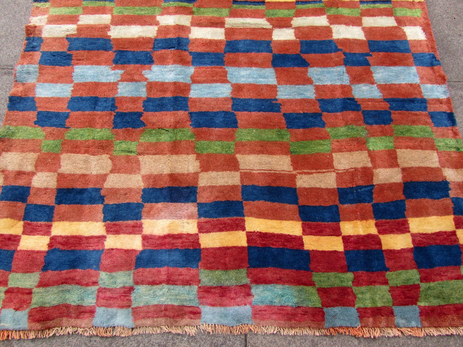 Handmade vintage Gabbeh style rug in geometric design. The rug is from the end of 20th century in original good condition.

- Condition: original good,

- circa 1970s,

- Size: 4.7' x 6.4' (137cm x 190cm),

- Material: wool,

- Country of
