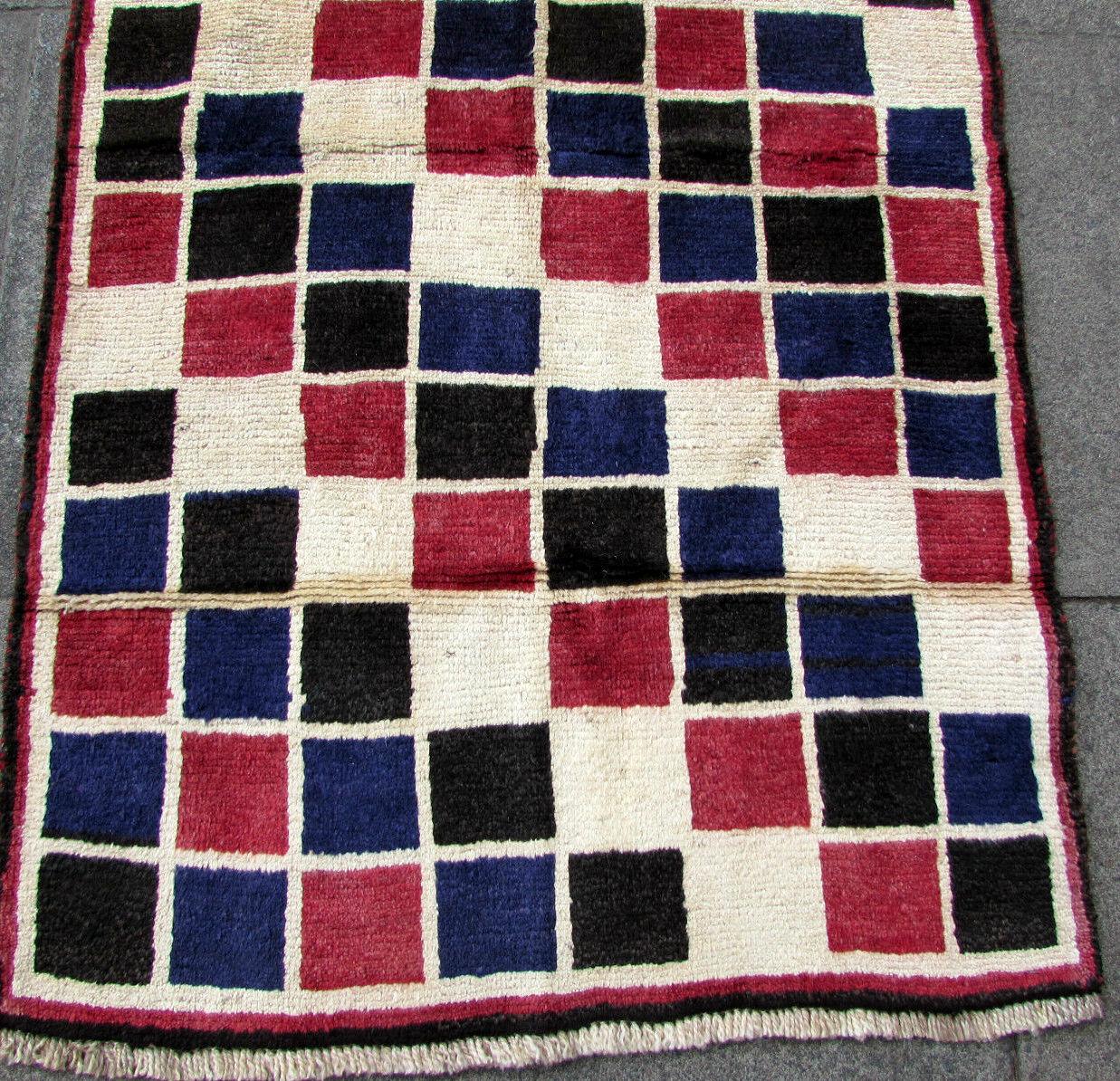 Handmade vintage Gabbeh style rug in geometric design. The rug is from the end of 20th century in original good condition.

-condition: original good,

-circa 1970s,

-size: 3.2' x 5.7' (94cm x 168cm),

-material: wool,

-country of