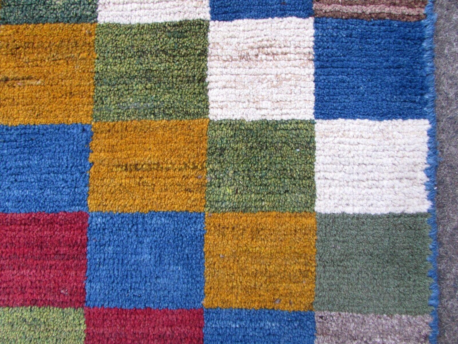 Handmade vintage Gabbeh rug in colorful wool. The rug is from the end of 20th century in original good condition.

-Condition: Original good,

-circa 1970s,

-Size: 3.4' x 4.6' (103cm x 140cm),

-Material: Wool,

-Country of origin: Middle