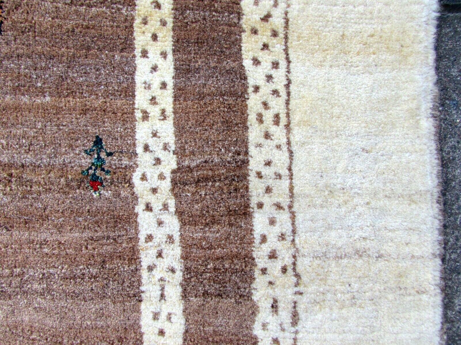 Handmade vintage Gabbeh rug in brown and beige wool. The rug is from the end of 20th century in original good condition.

- Condition: Original good,

- circa 1970s,

- Size: 3.7' x 5' (114cm x 153cm),

- Material: Wool,

- Country of