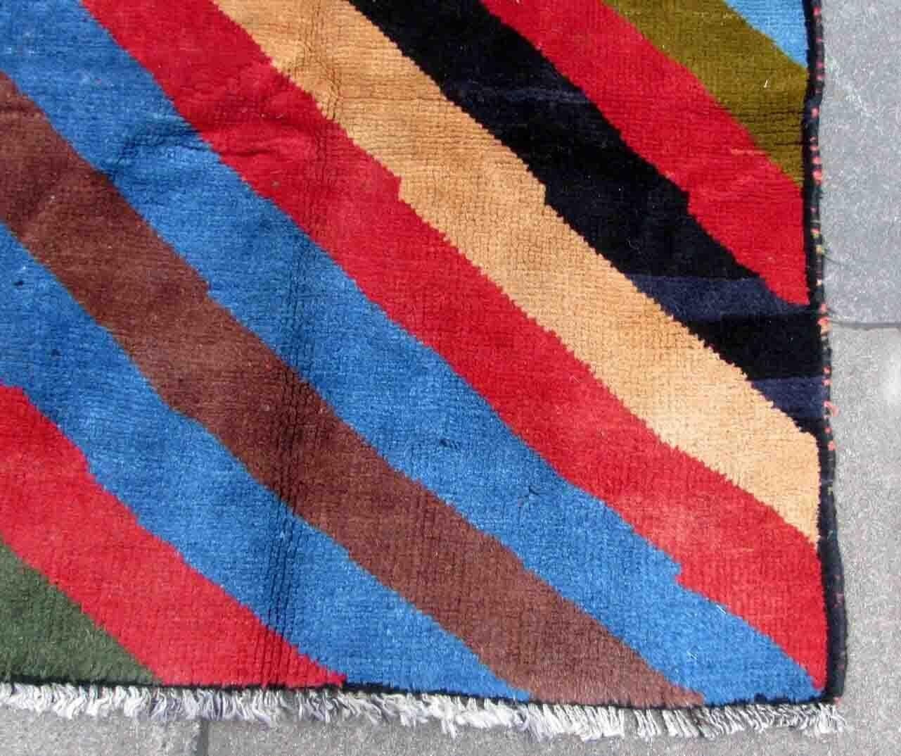 Handmade vintage Gabbeh rug in colorful geometric striped design. The rug is from the end of 20th century in original good condition.

-Condition: original good,

-circa: 1970s,

-Size: 3.8' x 4.8' (117cm x 147cm),

-material: