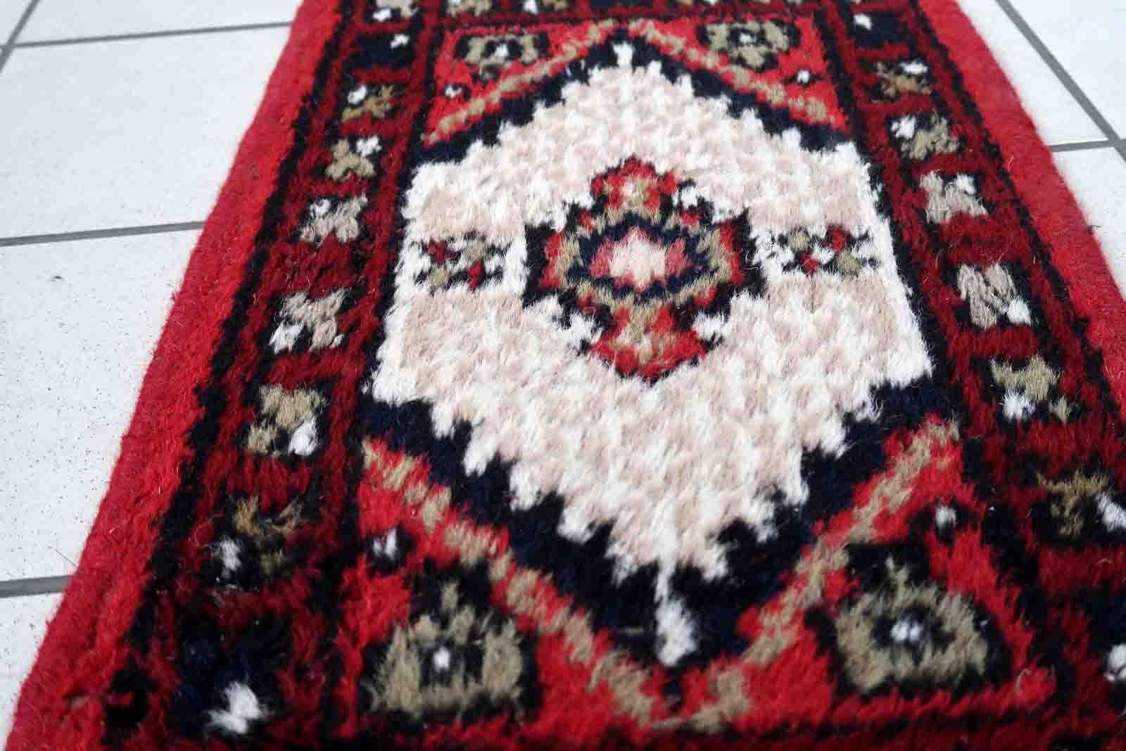 Handmade vintage Middle Eastern rug in traditional medallion design. The rug has been made in wool in the end of 20th century. It is in original condition, has some low pile.

-condition: original, some low pile,

-circa: 1970s,

-size: 1.3' x