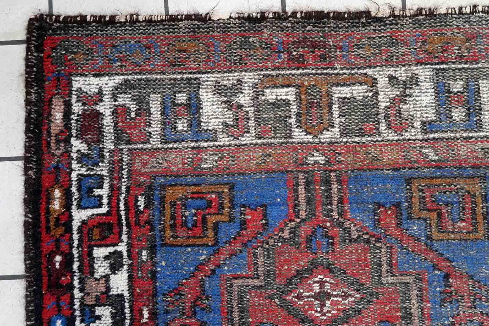 Handmade vintage Hamadan rug in geometric design with large medallion. The rug is from the end of 20th century in distressed condition.

-condition: distressed,

-circa: 1970s,

-size: 3.3' x 6.4' (101cm x 197cm),

-material: