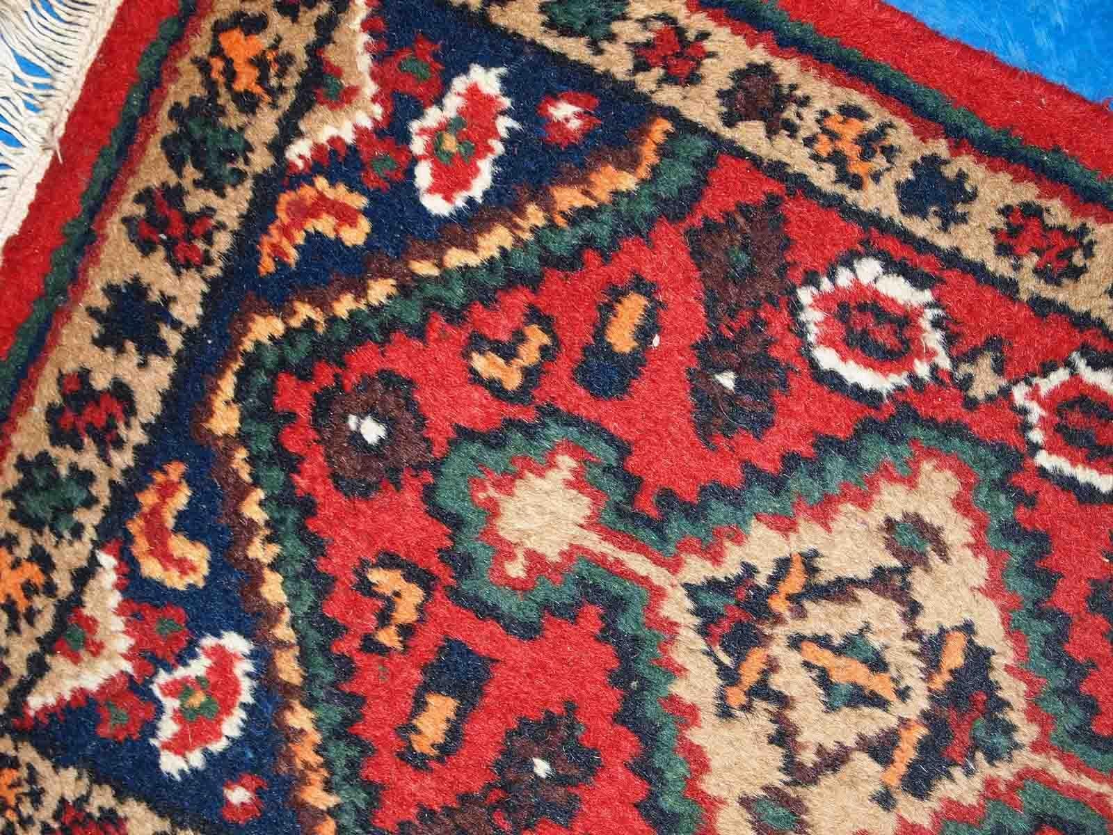 Vintage handmade Middle Eastern mat in original good condition. The rug is from the end of 20th century.

-condition: original good, 

-circa: 1970s,

-size: 1.3' x 2' (41cm x 61cm),

-material: wool,

-country of origin: Middle