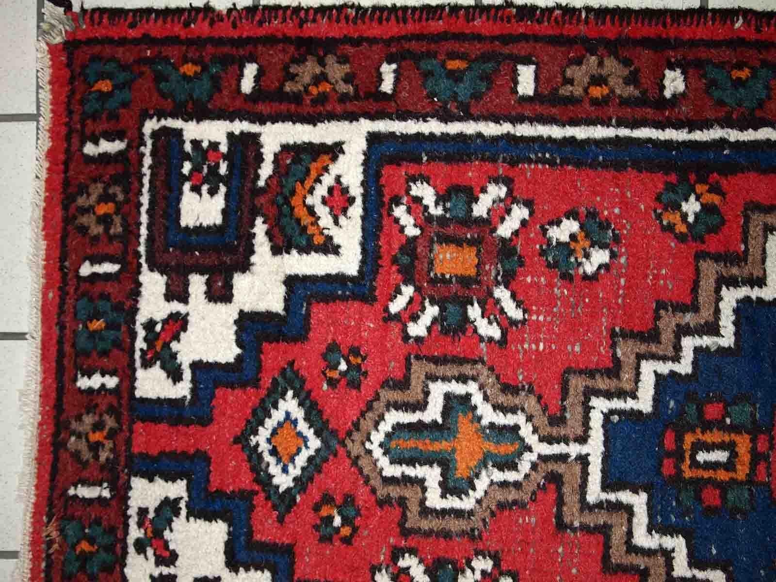 Handmade vintage Middle Eastern rug in traditional design. The rug is from the end of 20th century in original condition, it has some signs of age.

-condition: origial, some signs of age, 

-circa: 1970s,

-size: 2.4' x 4.6' (75cm x