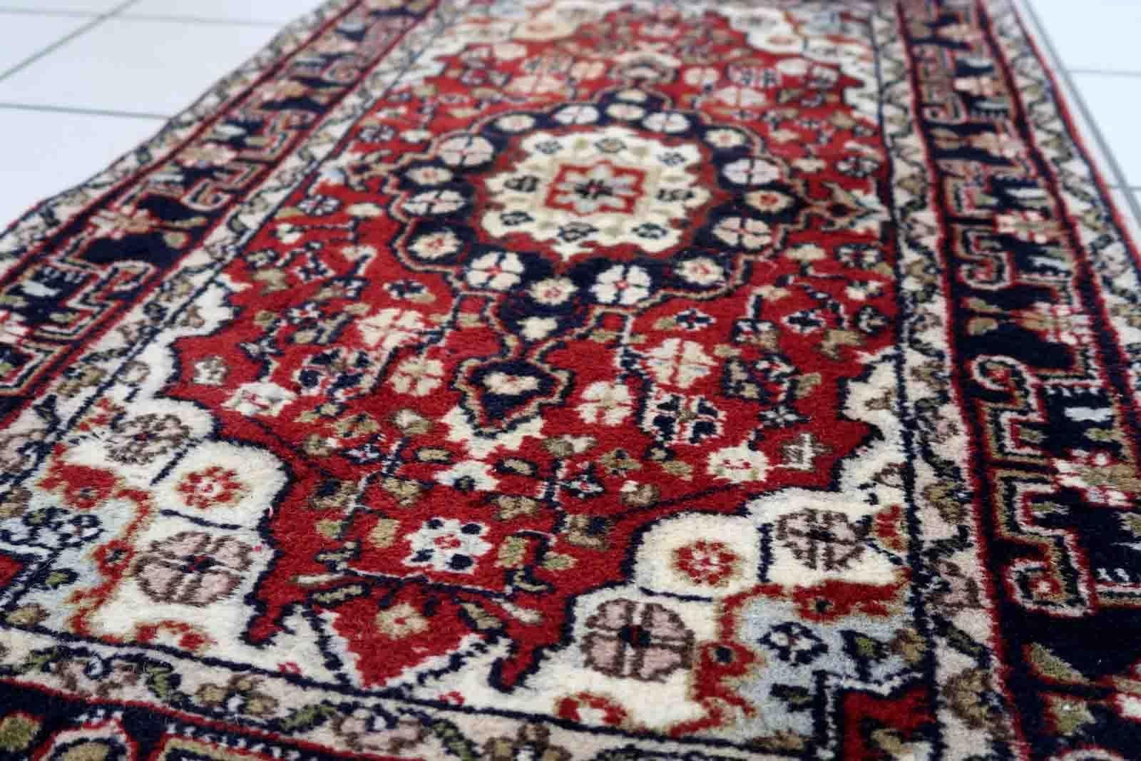 Handmade vintage Middle Eastern rug in traditional medallion design. The rug has been made in wool in the end of 20th century. It is in original good condition

-condition: original good,

-circa: 1970s,

-size: 1.9' x 3.2' (60cm x
