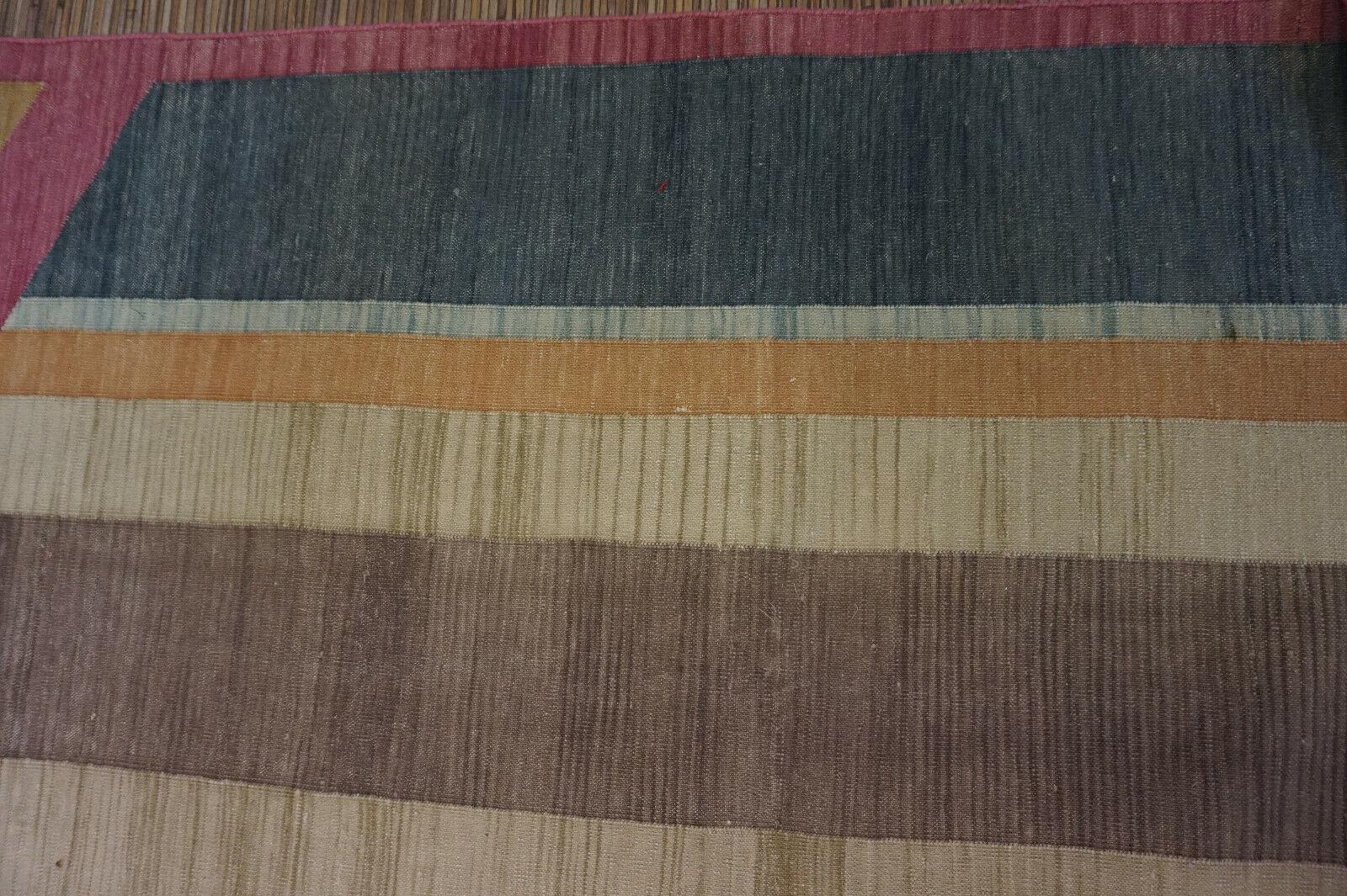 Verschönern Sie Ihr Zuhause mit diesem fesselnden handgefertigten indischen Dhurrie-Kilim-Teppich im Vintage-Stil aus den 1970er Jahren. Mit den Maßen 6,3' x 8,3' bietet dieser Teppich einen sonnig-gelben Hintergrund, der mit zwei großen