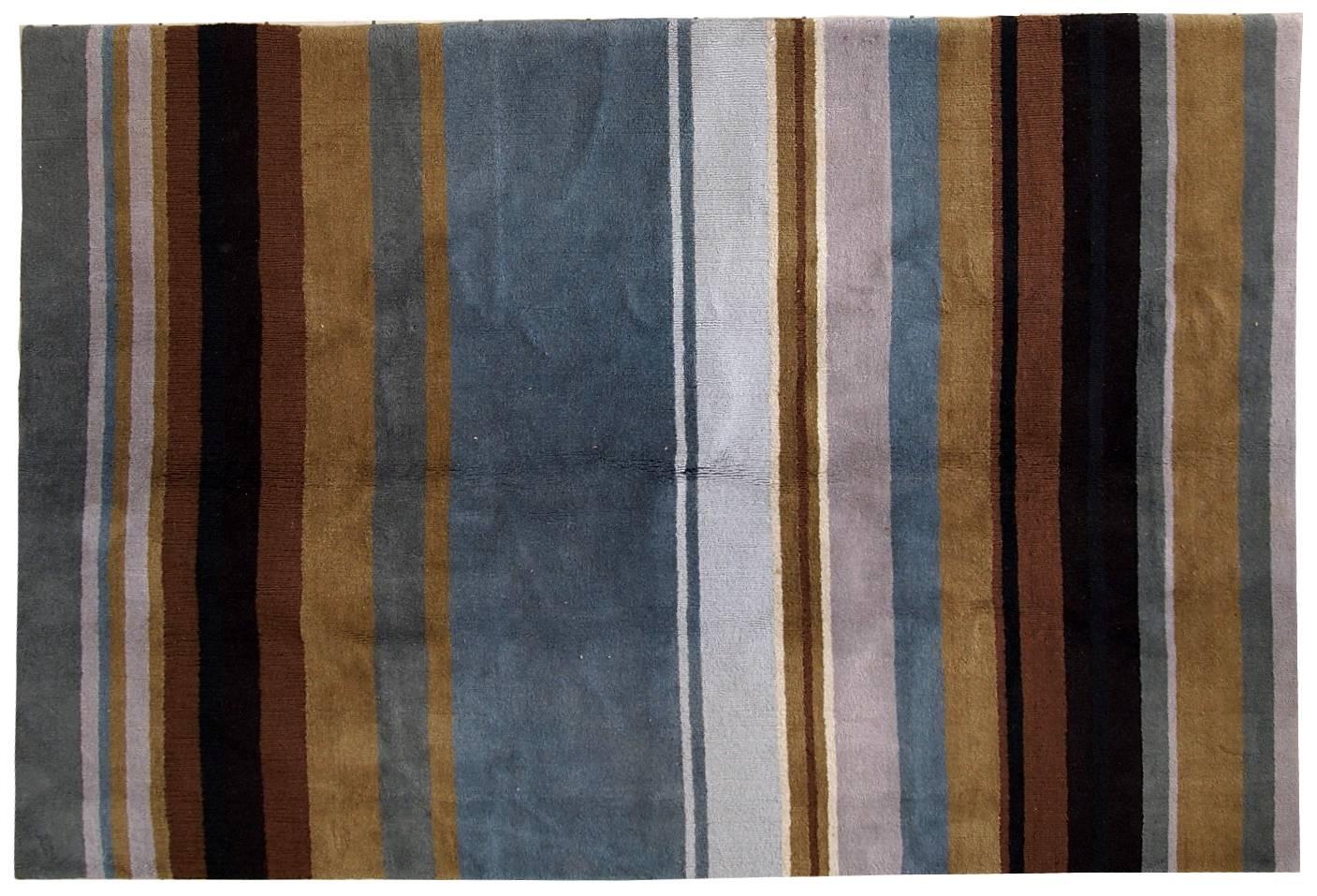 Vintage handmade Indian striped rug in blue, purple and different shades of brown. Each line of the rug made in different technics as well, so the pattern on it changes. The rug is very thick, heavy and soft, made out of wool. 
 