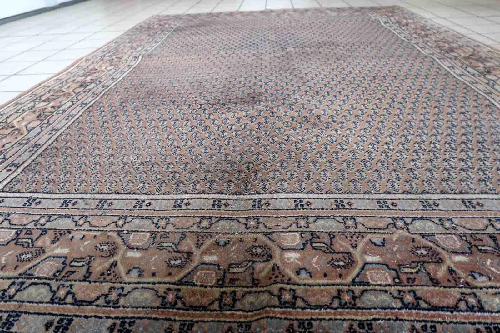 Handmade vintage Indian with Persian Seraband design in unusual brown color. The rug is from the end of 20th century in original good condition, it has minimal signs of age.

-condition: original good,

-circa: 1970s,

-size: 5.5' x 7.7'