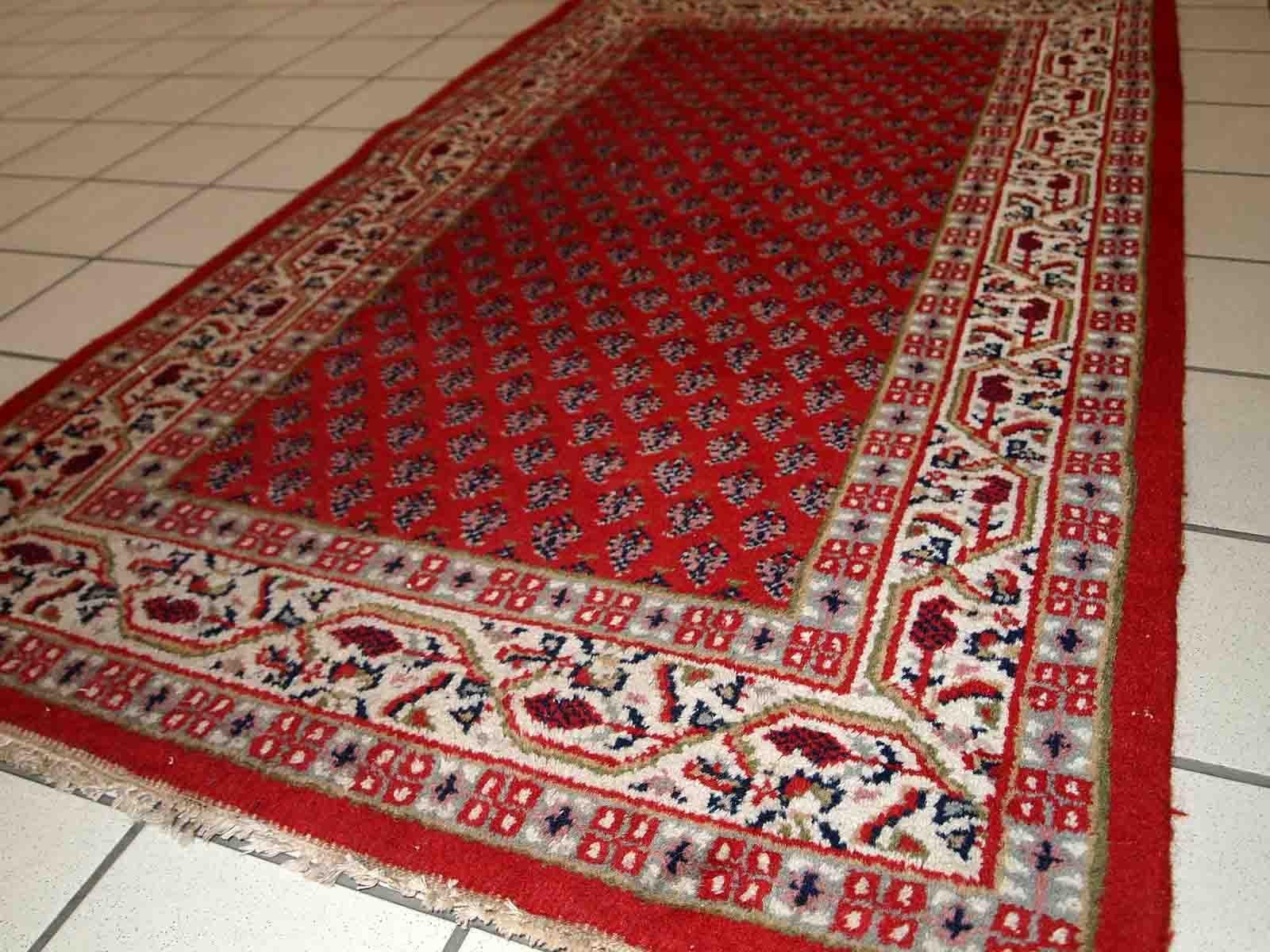 Vintage handmade Middle Eastern rug from the end of 20th century. The rug is in original good condition. It is in traditional classic design.

-condition: original good, 

-circa: 1970s,

-size: 3' x 5.3' (93cm x 162cm),

-material: