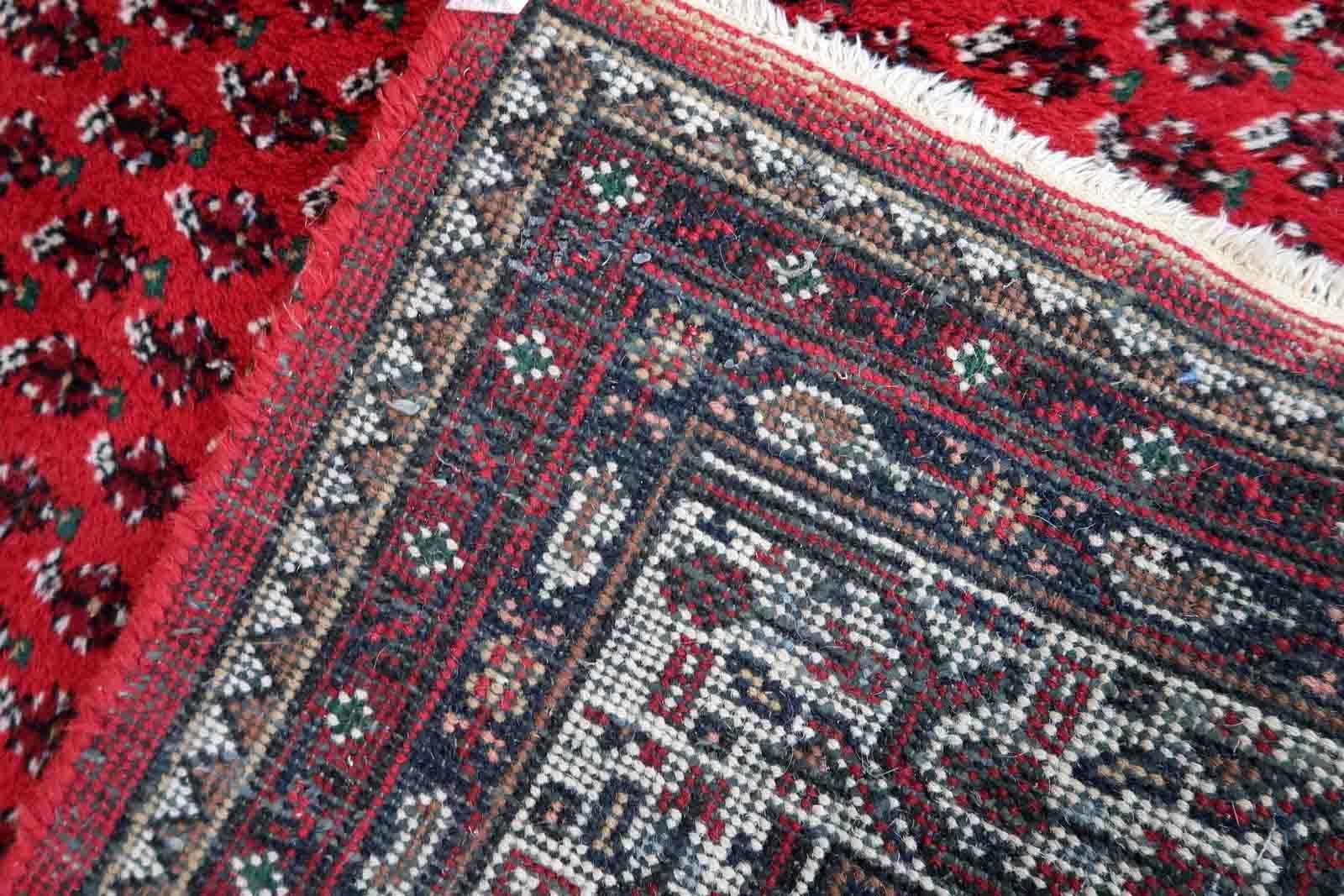 Handmade vintage Indian Seraband rug in original condition, it has some age wear on the one end. The rug has been made in traditional pattern, it is from end of 20th century. The shades of the rug are mostly in red and white. All-over design will