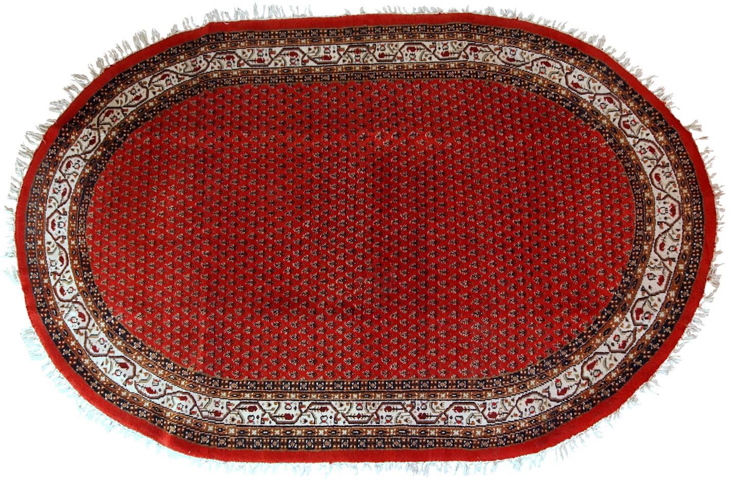 Vintage handmade Indian rug with Persian Seraband design in red with white border. All-over design with repeating pattern. The rug is from the end of 20th century in original good condition.
 