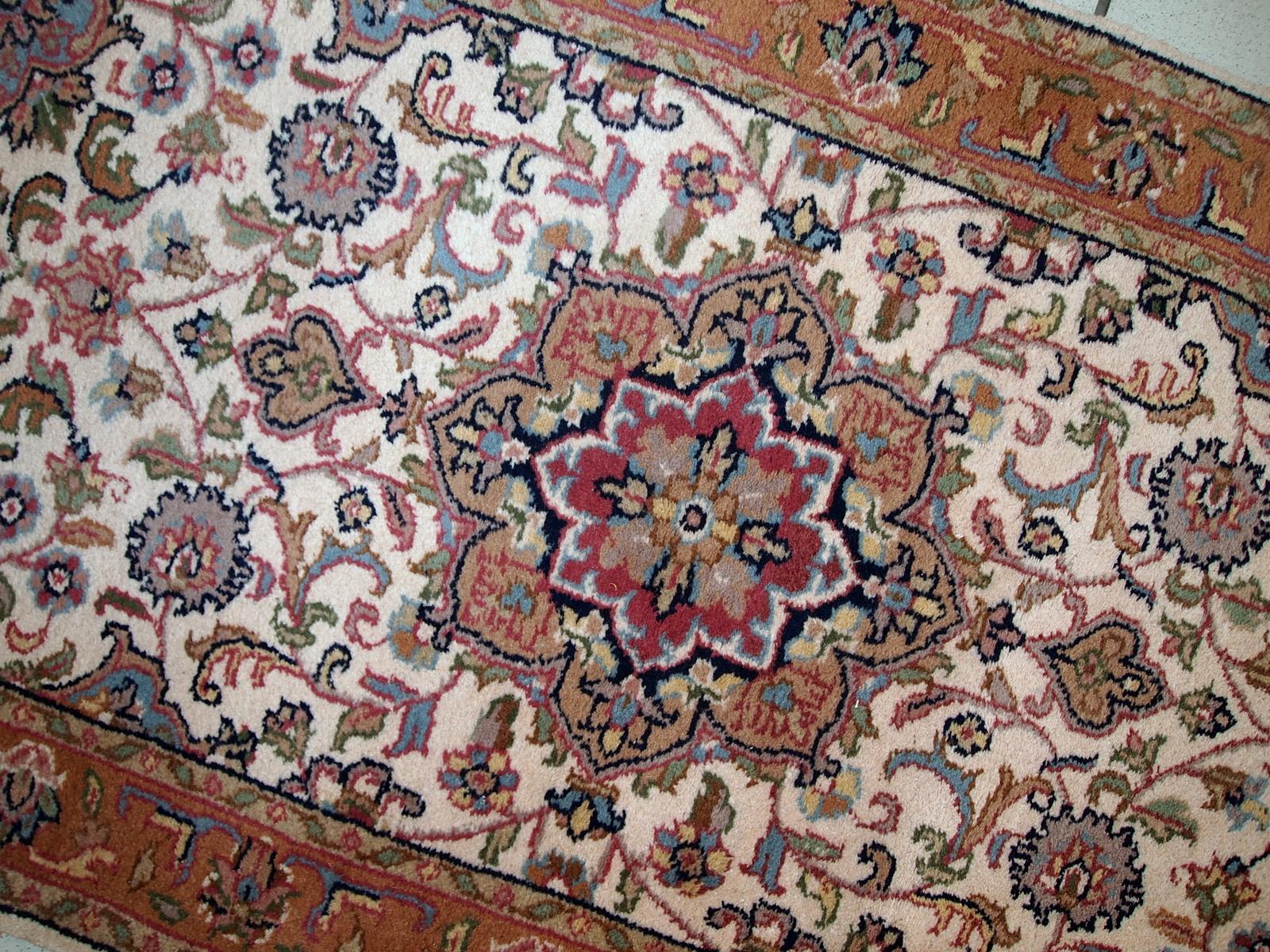 Vintage Indo-Tabriz rug in original good condition. This rug has been made in the middle of 20th century in India.

-condition: original good, 

-circa 1970s,

-size: 2.4' x 4.8' (74cm x 146cm),

-material: wool,

-country of origin: